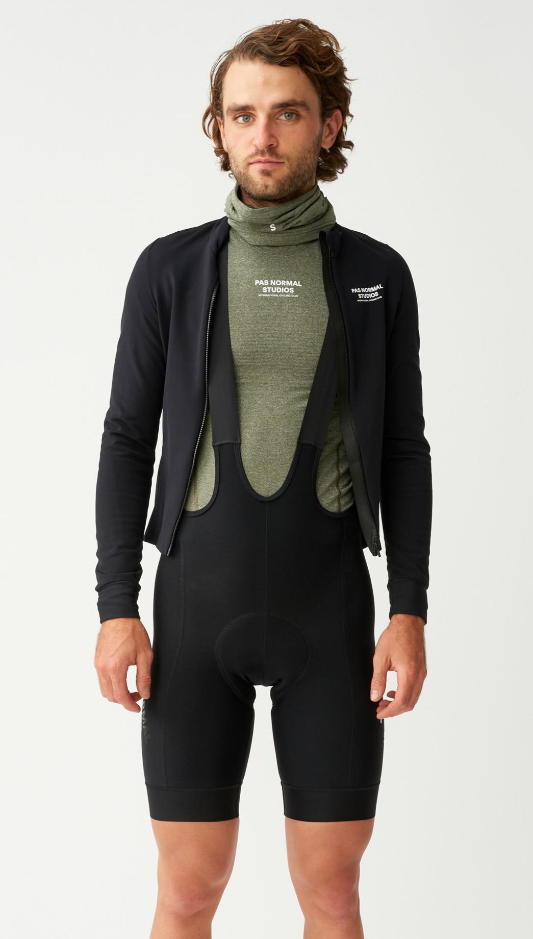 Black Mechanism Thermal long sleeve cycling jersey on model with open black jacket and bib shorts