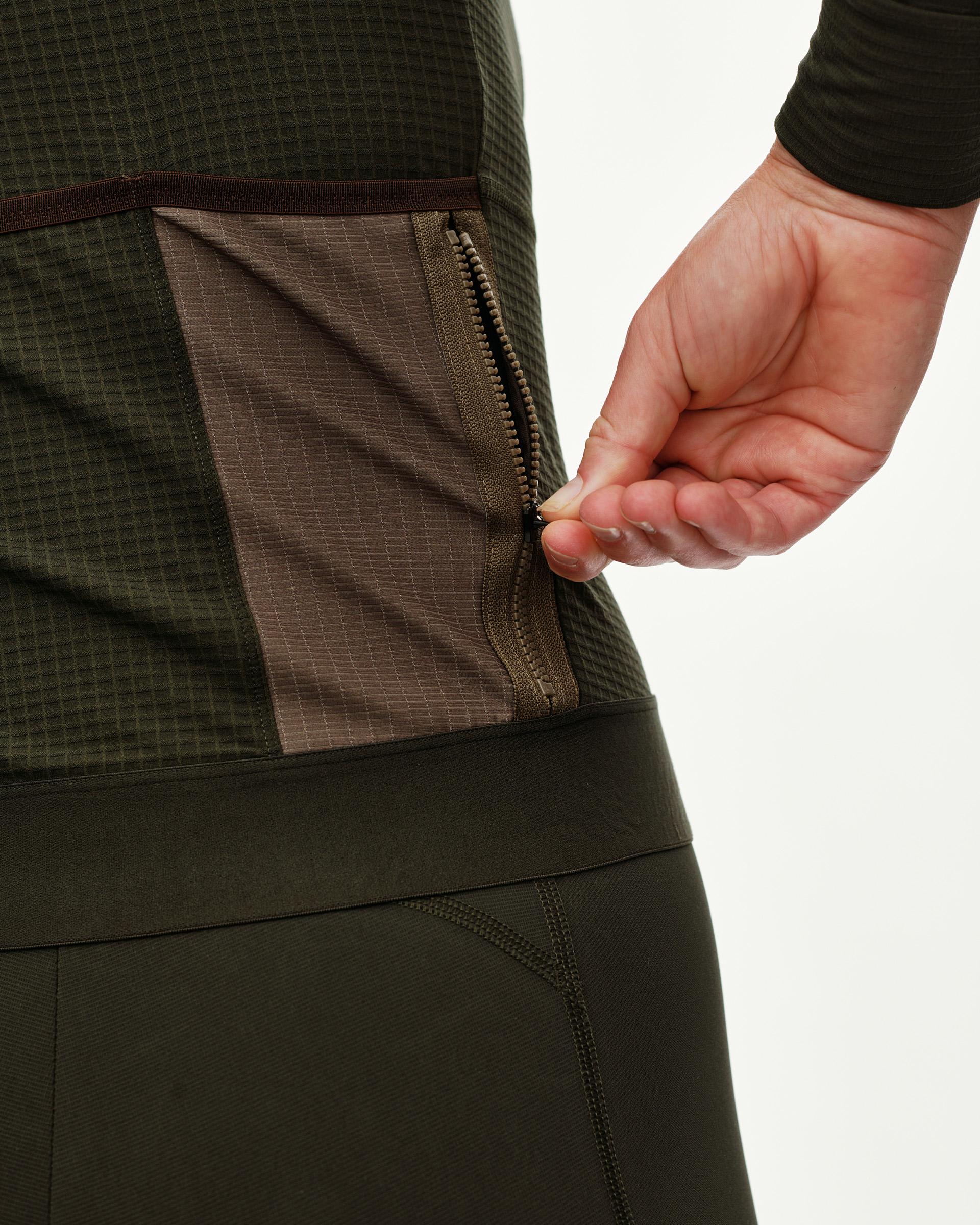 Dark Olive Escapism long sleeve cycling jersey, detail view of zip rear pocket on model