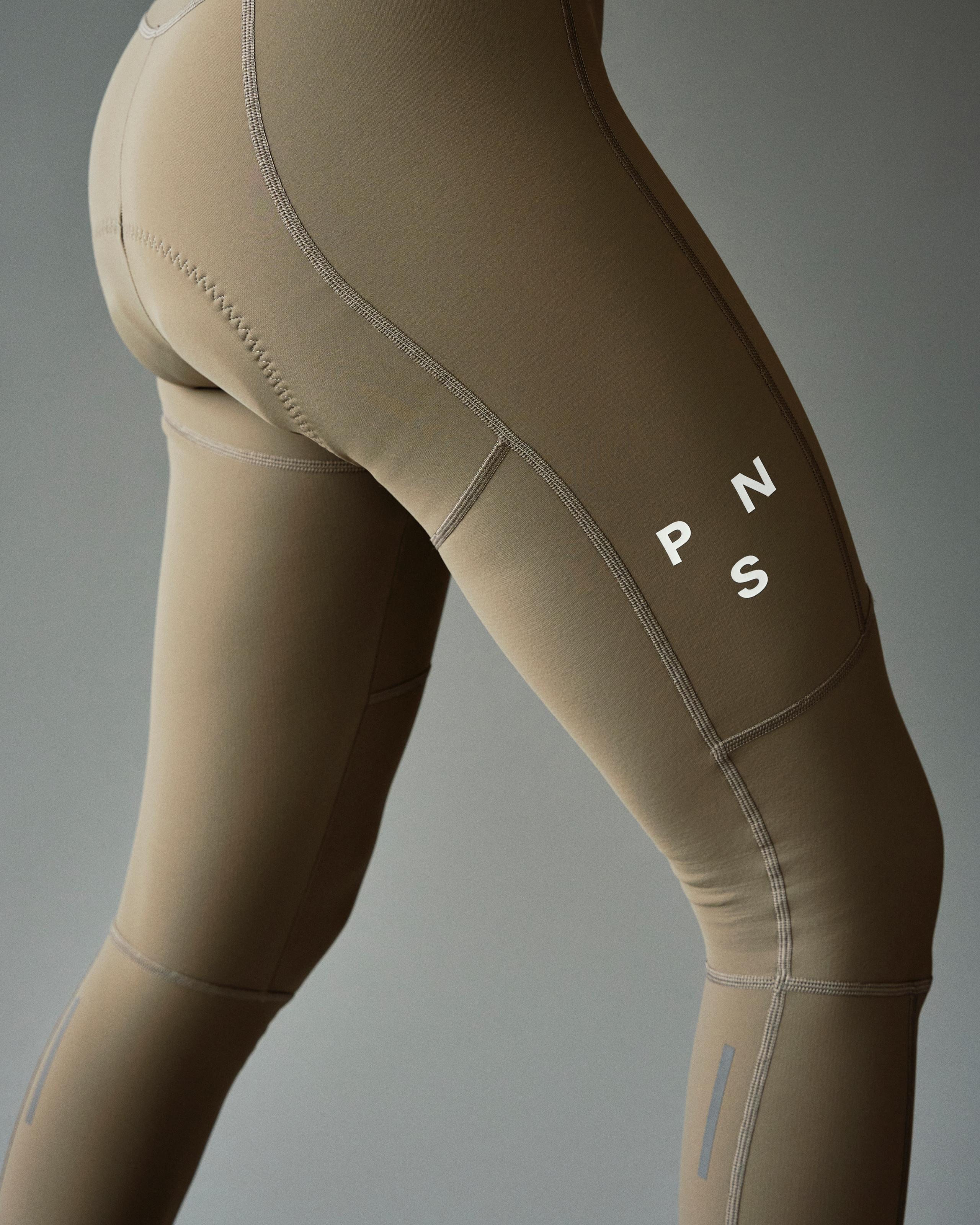 Dark Stone Mechanism Deep Winter Long cycling bibs on model with contrast stitching and white PNS logo