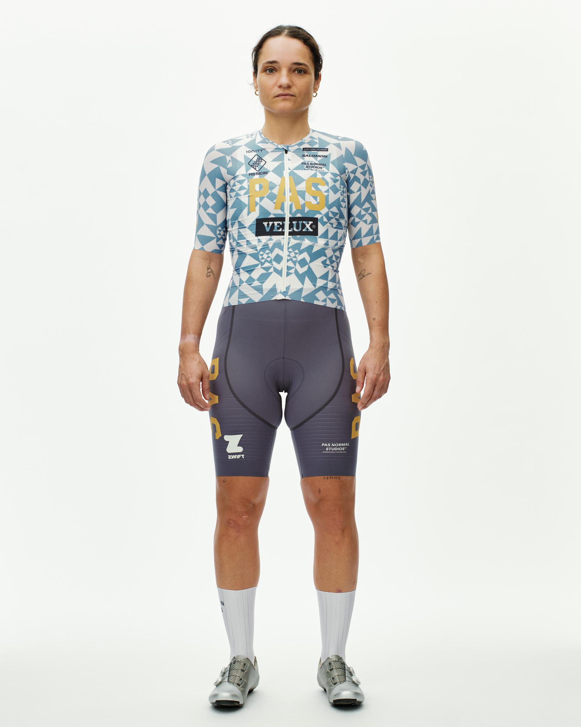 Origami Light Blue PAS Mechanism Pro women's cycling jersey on model, front view with geometric print and gold chest logo