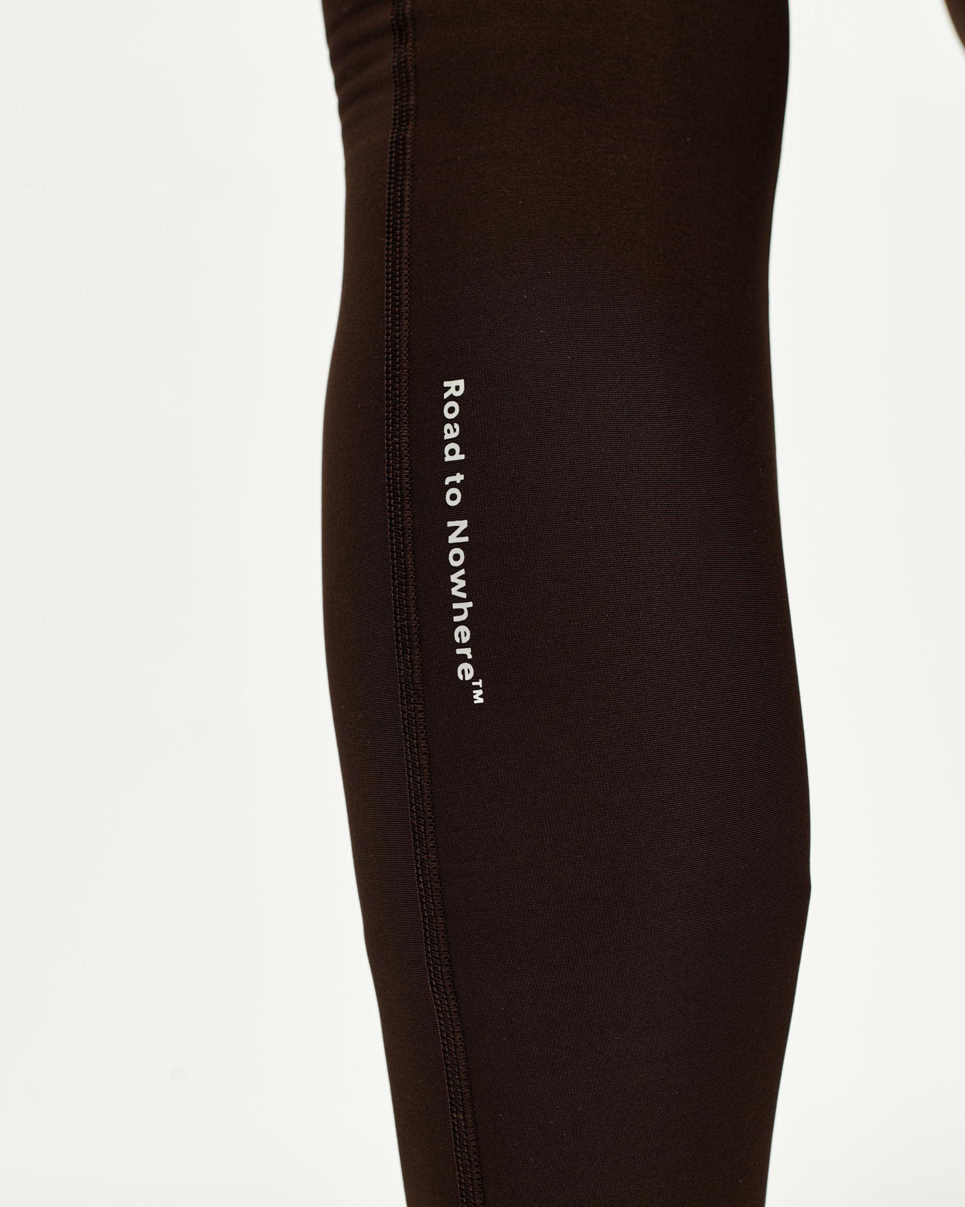 Dark Coffee Mechanism Thermal Long cycling bibs, side detail view with white Road to Nowhere side print