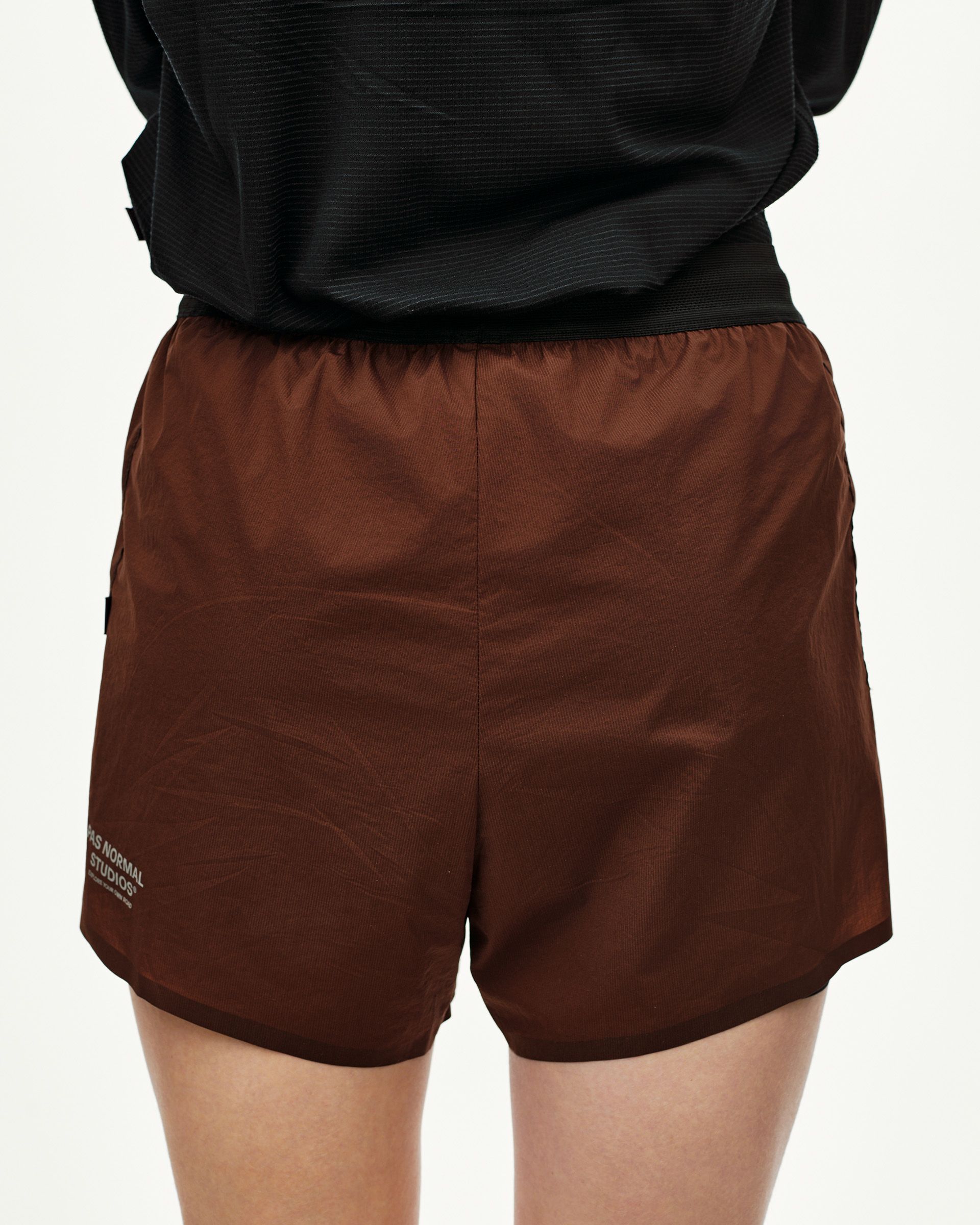 Maroon Brown Balance 2-in-1 shorts on model, rear view with elastic waistband and side zip pocket