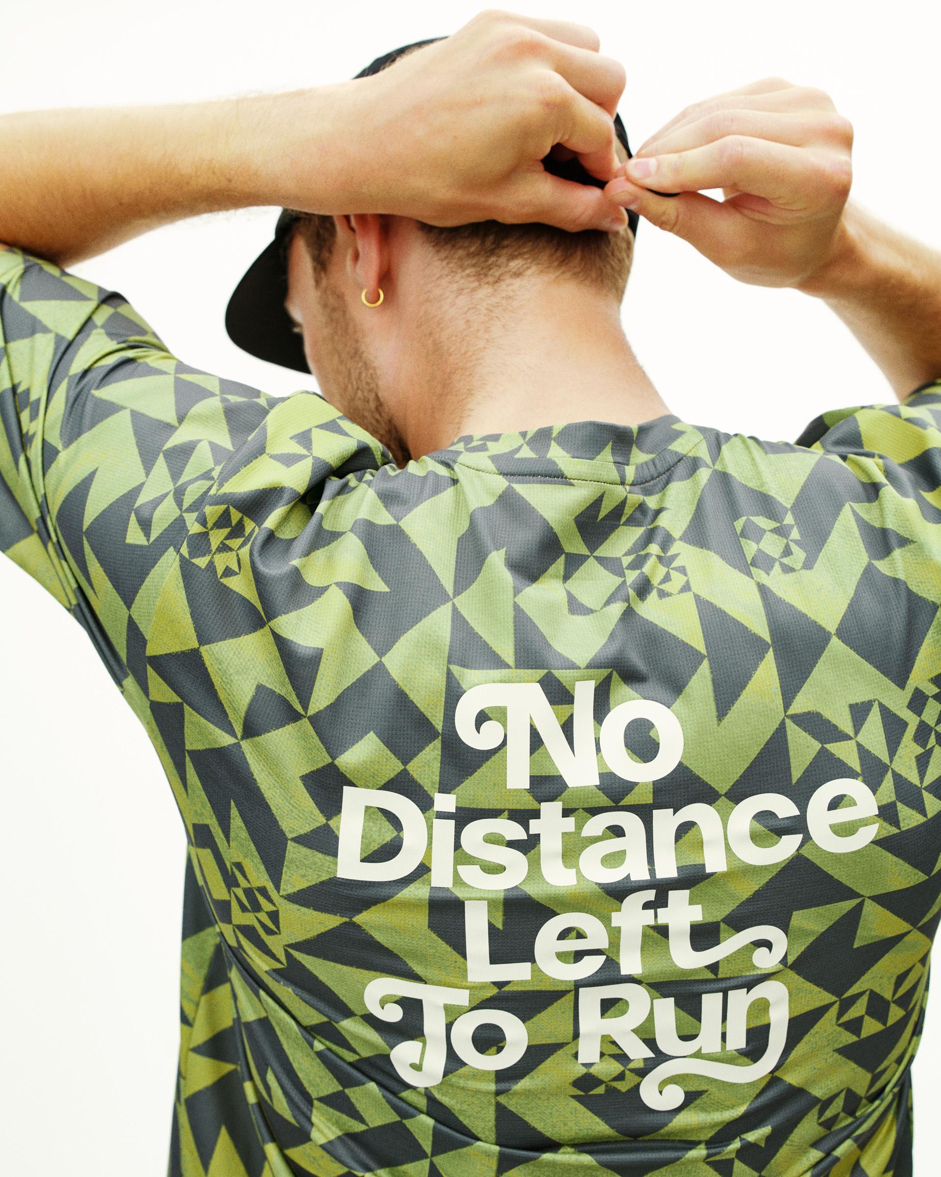 Green Balance t-shirt on model, rear view with geometric origami print and white text