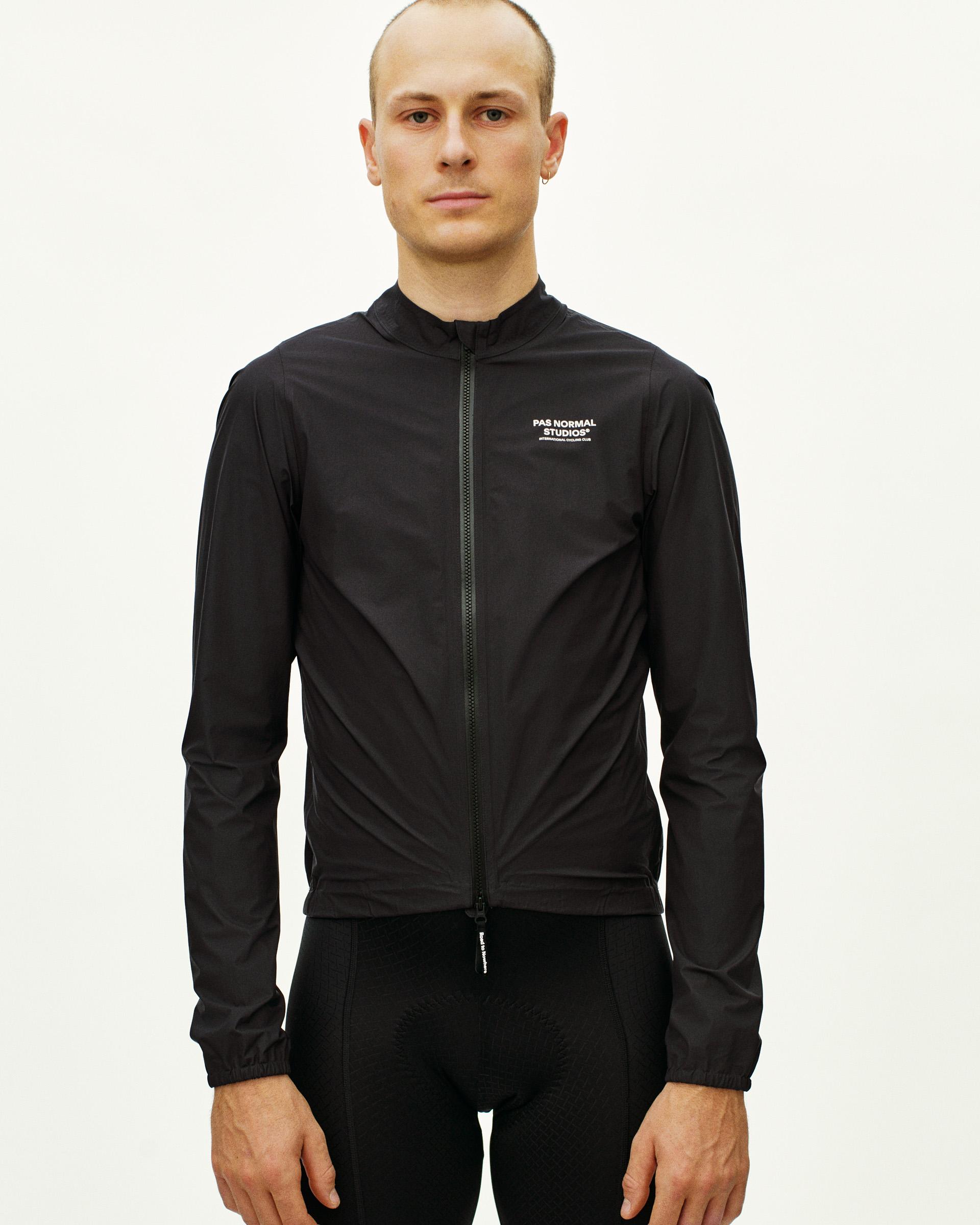 Black Mechanism Rain cycling jacket on model, front view with full zip and white chest logo