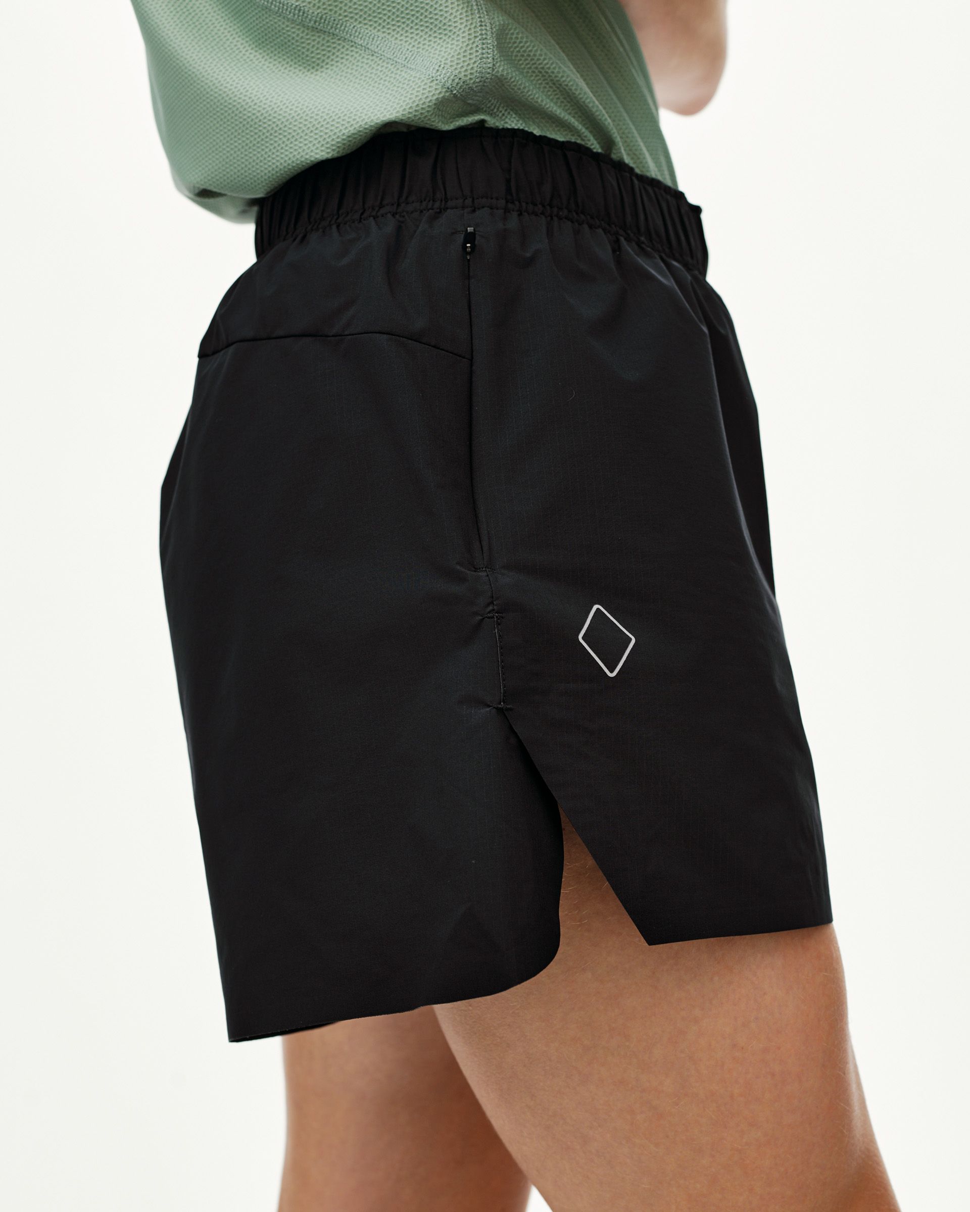 Black Balance shorts on model, side view with elastic waistband and diamond logo patch