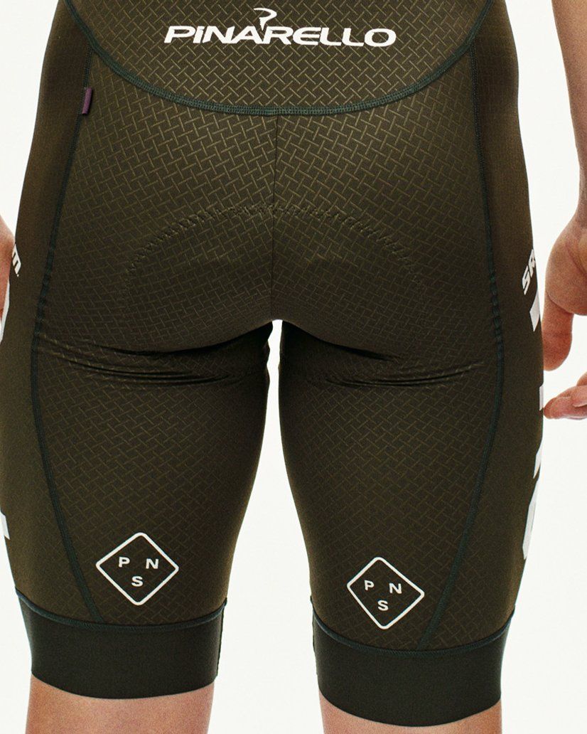 Beige STFR Mechanism long sleeve speedsuit, rear view on model with diamond-textured fabric