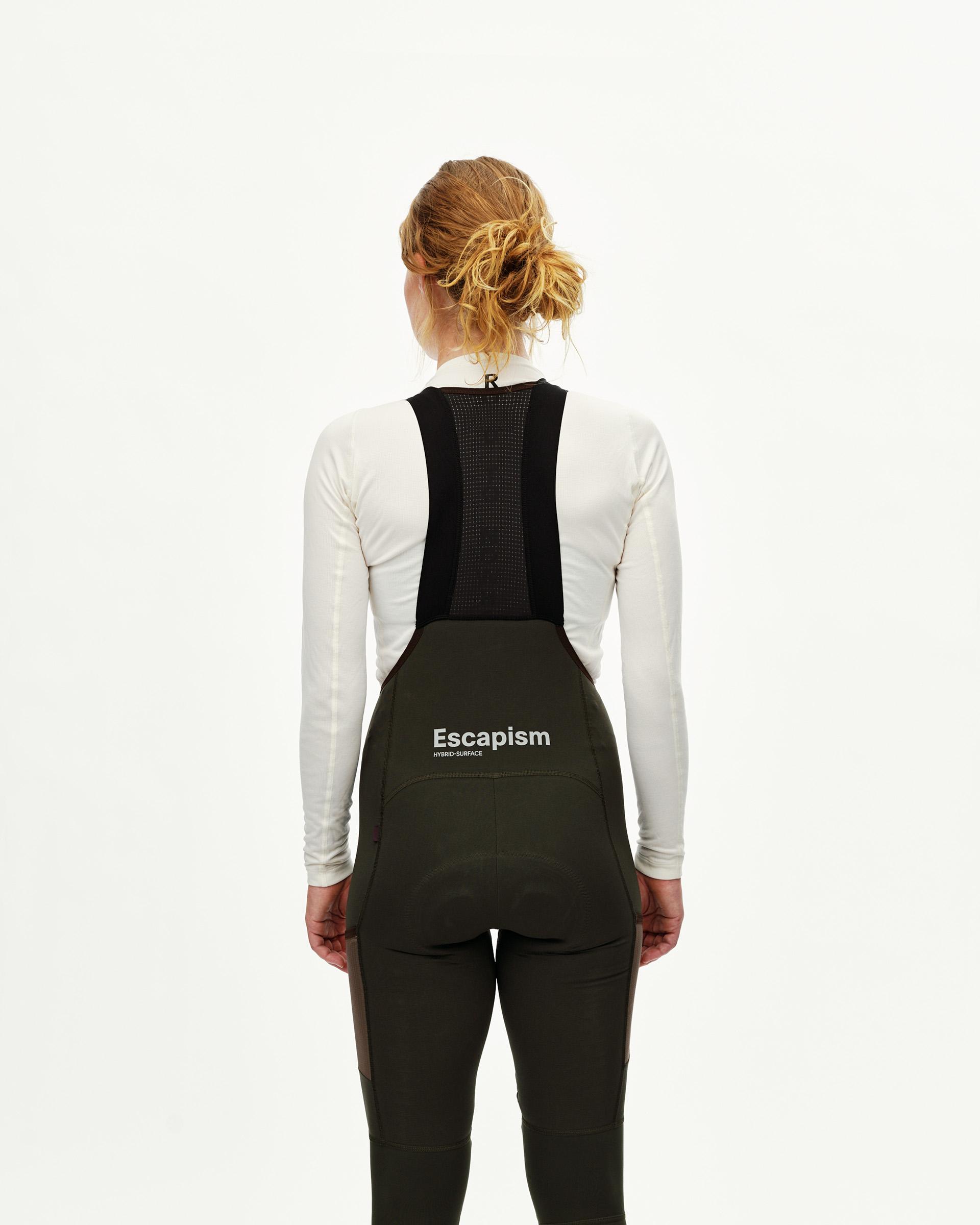Dark Olive Escapism Long Cargo cycling bibs on model, rear view with mesh bib straps and white back print