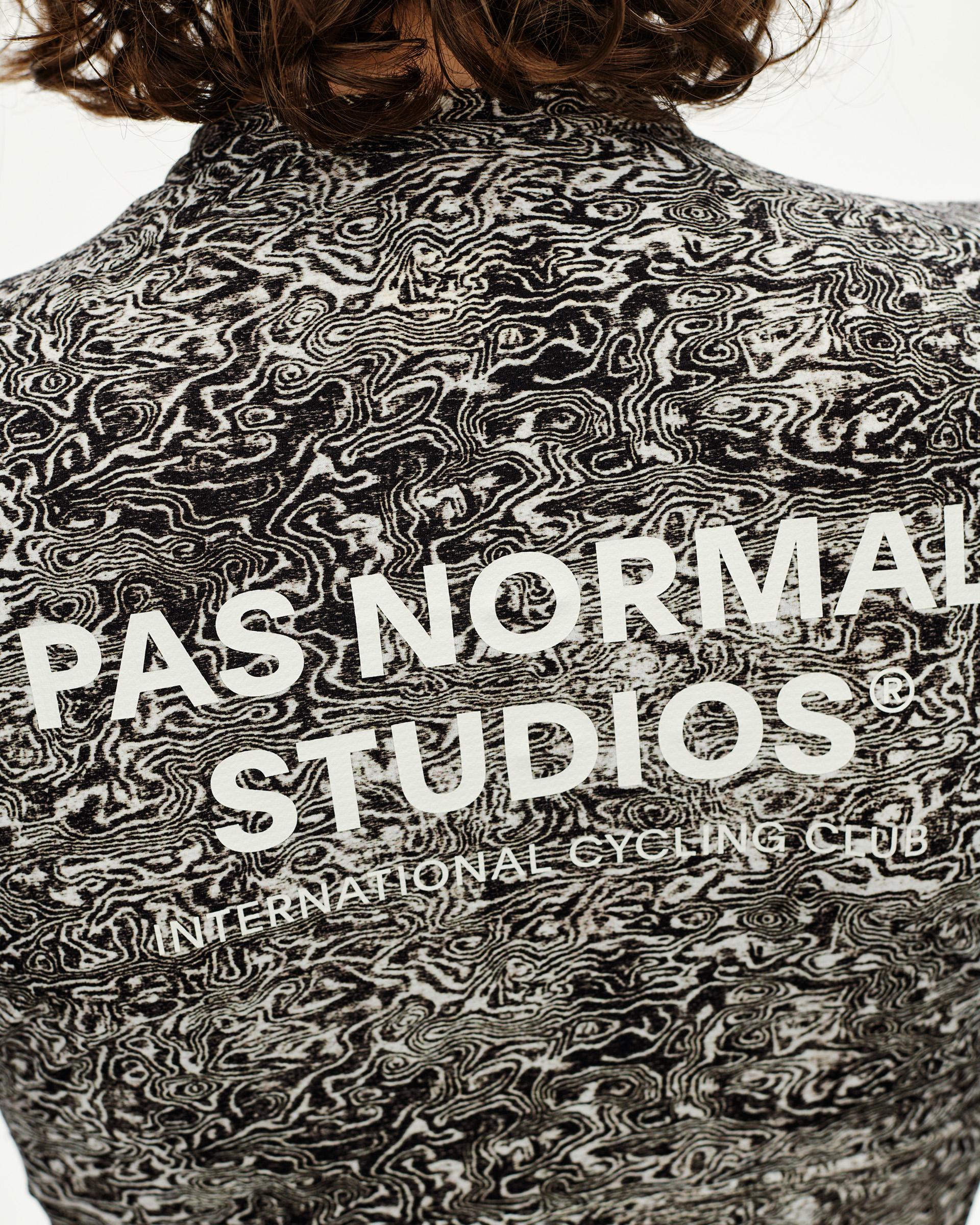 Off White Essential cycling jersey on model, rear detail with swirling black AOP print and large back logo