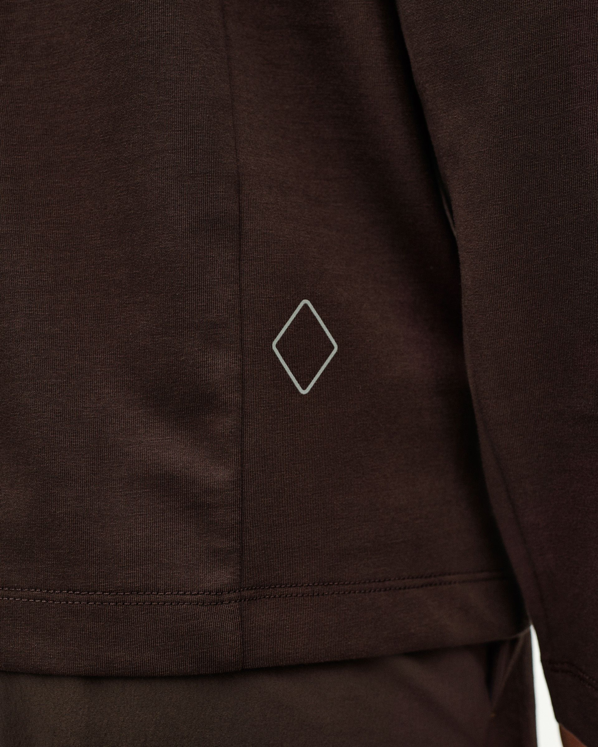 Dark Purple Off-Race Cotton Tech long sleeve t-shirt detail view with white diamond logo on hem