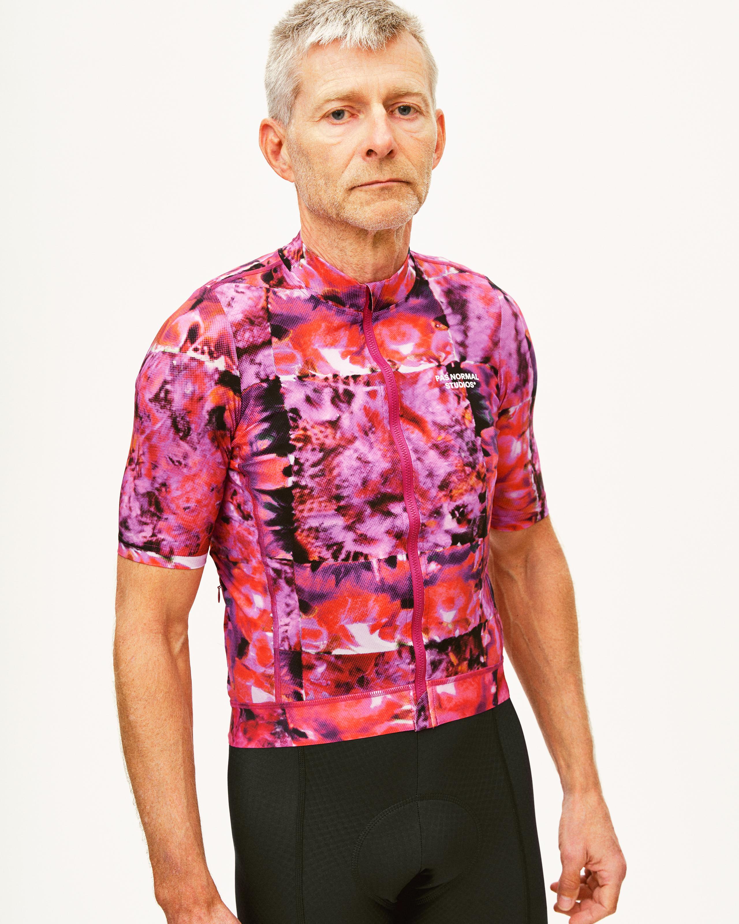 Black Essential cycling bibs on model, front view worn under floral jersey