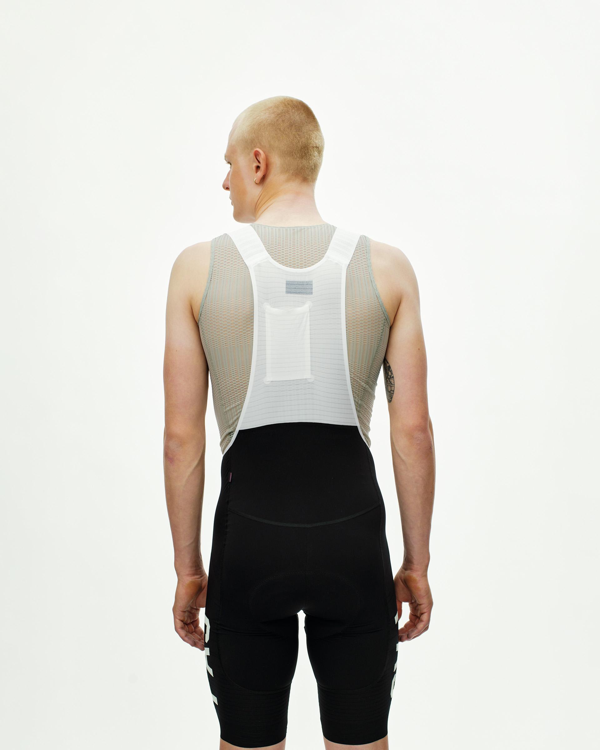 Black PAS Mechanism Pro cycling bibs on model, rear view with white mesh panel and back pocket