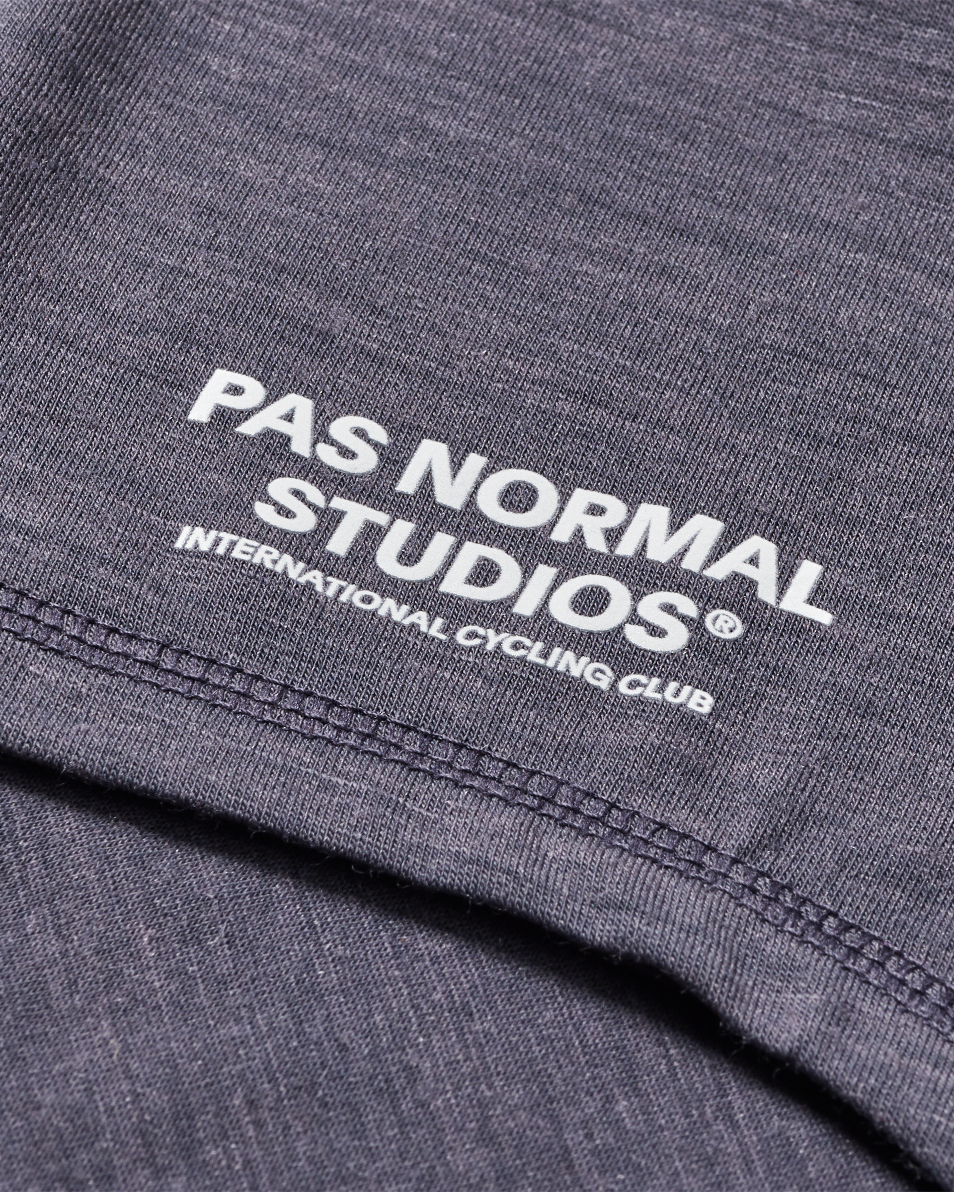 Grey Logo Merino necktube, detail view showing white logo print and contrast stitching