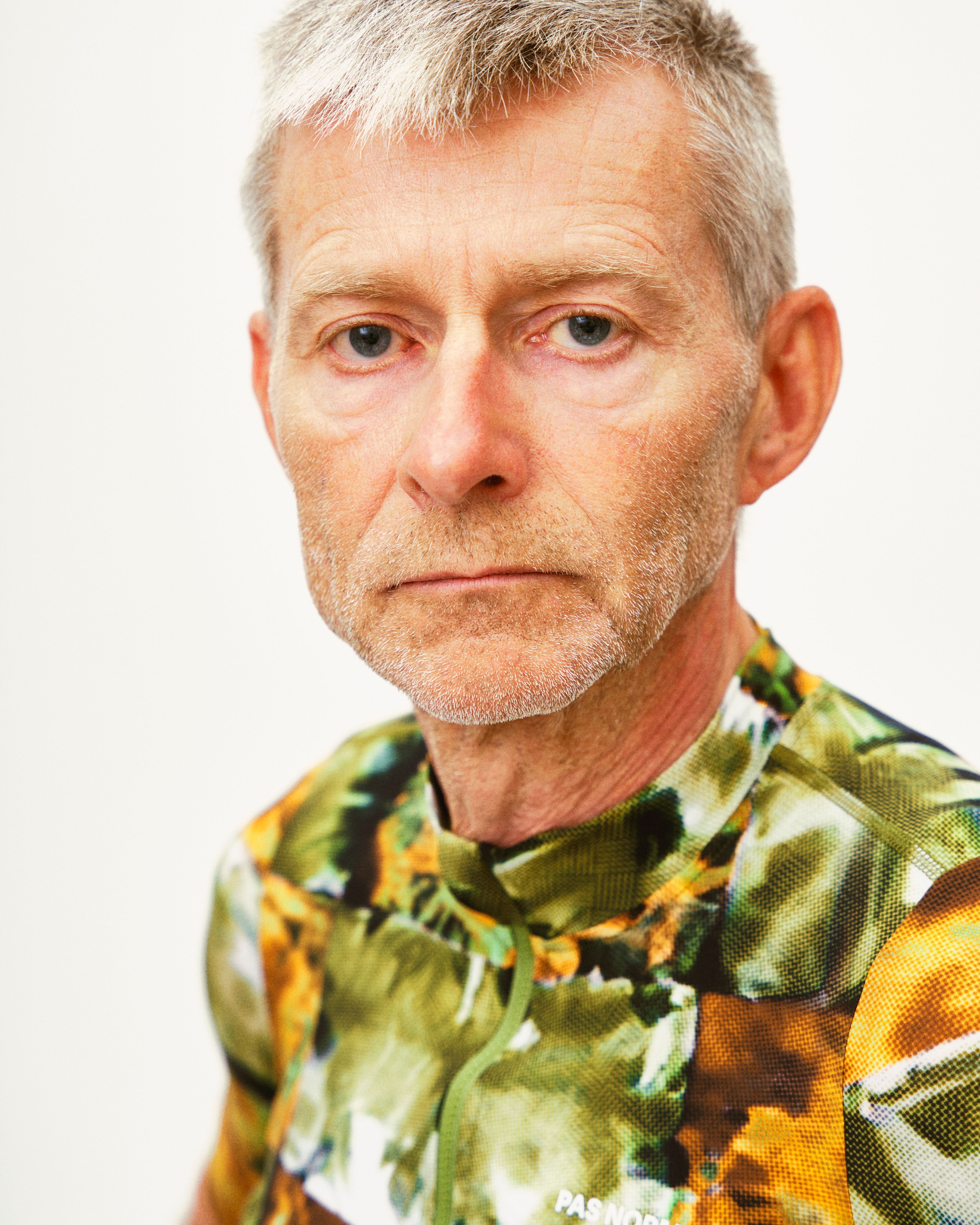 Model wearing Essential jersey with green and orange floral print pattern