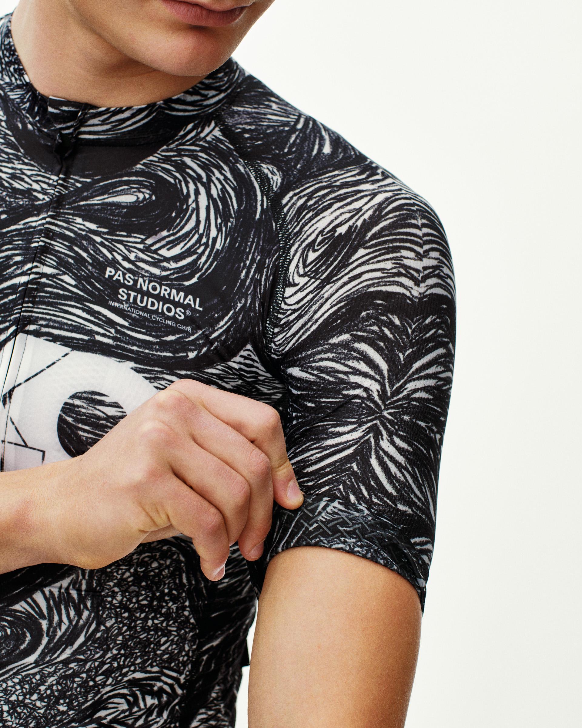 Iron Grey T.K.O. Mechanism cycling jersey, front detail on model with black-and-white swirl all-over print