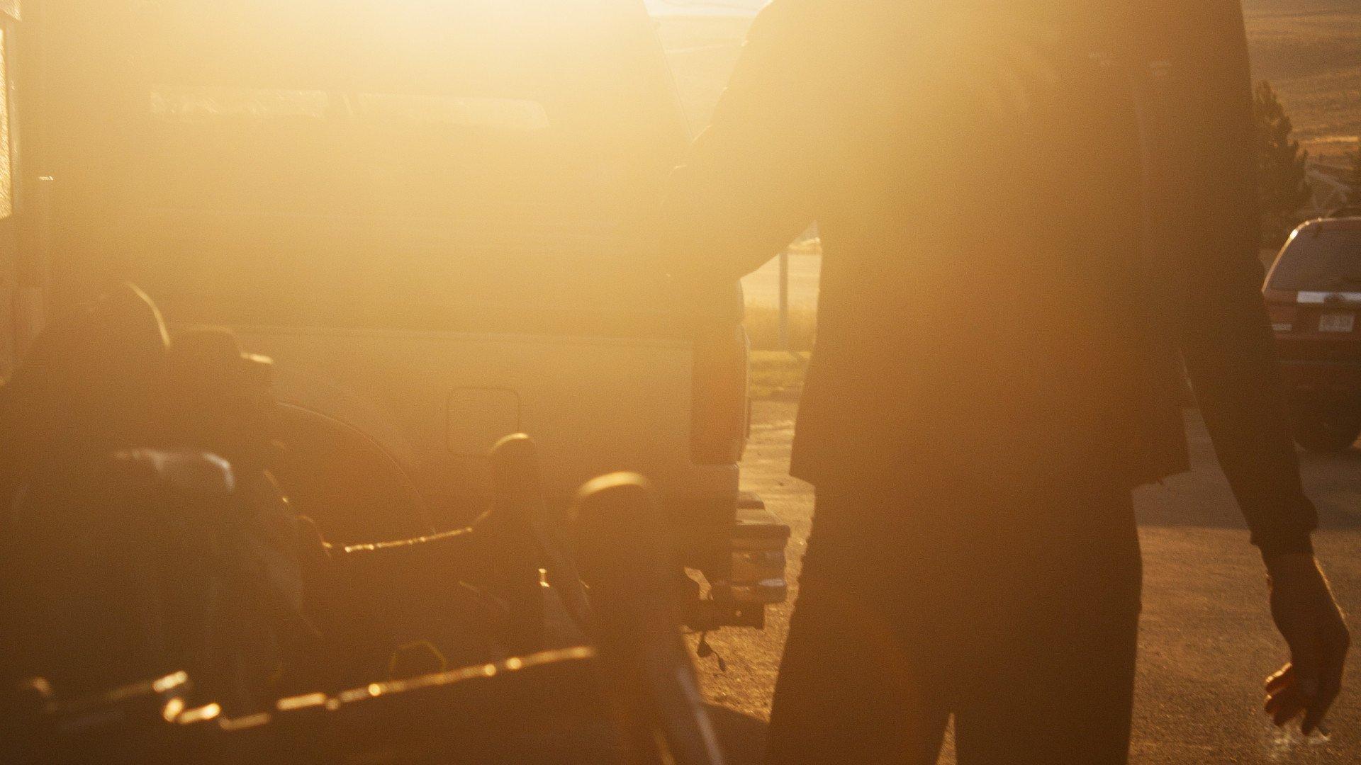 Cyclist silhouette with bike in golden sunset light