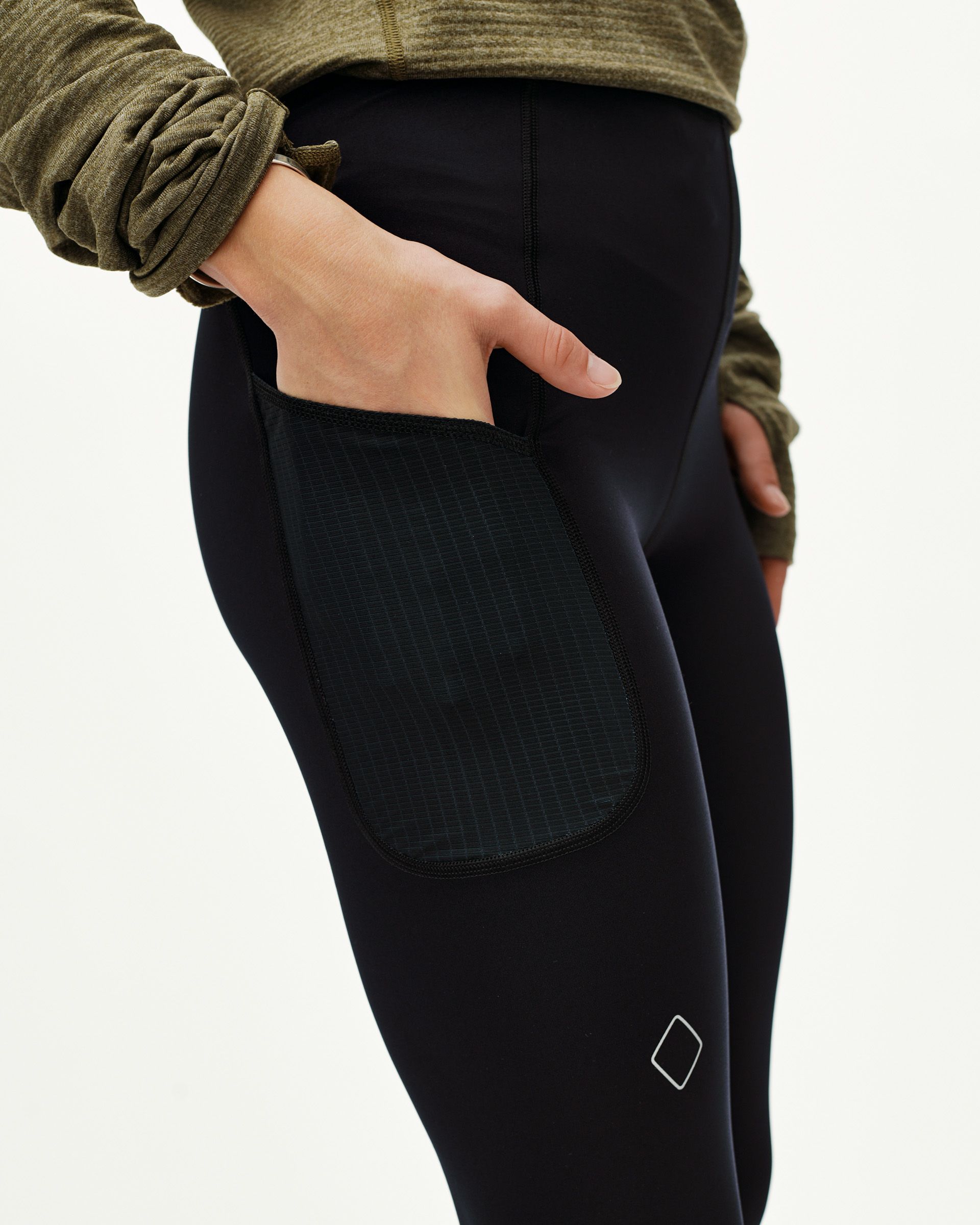 Black Balance long tights, side detail on model with hand in ripstop thigh pocket