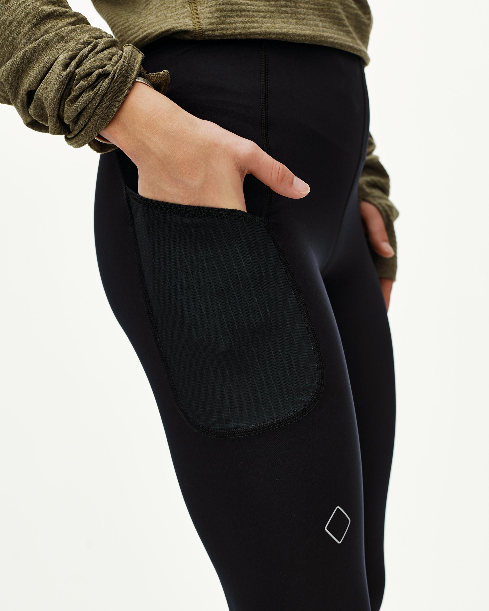 Black Balance long tights, side detail on model with hand in ripstop thigh pocket