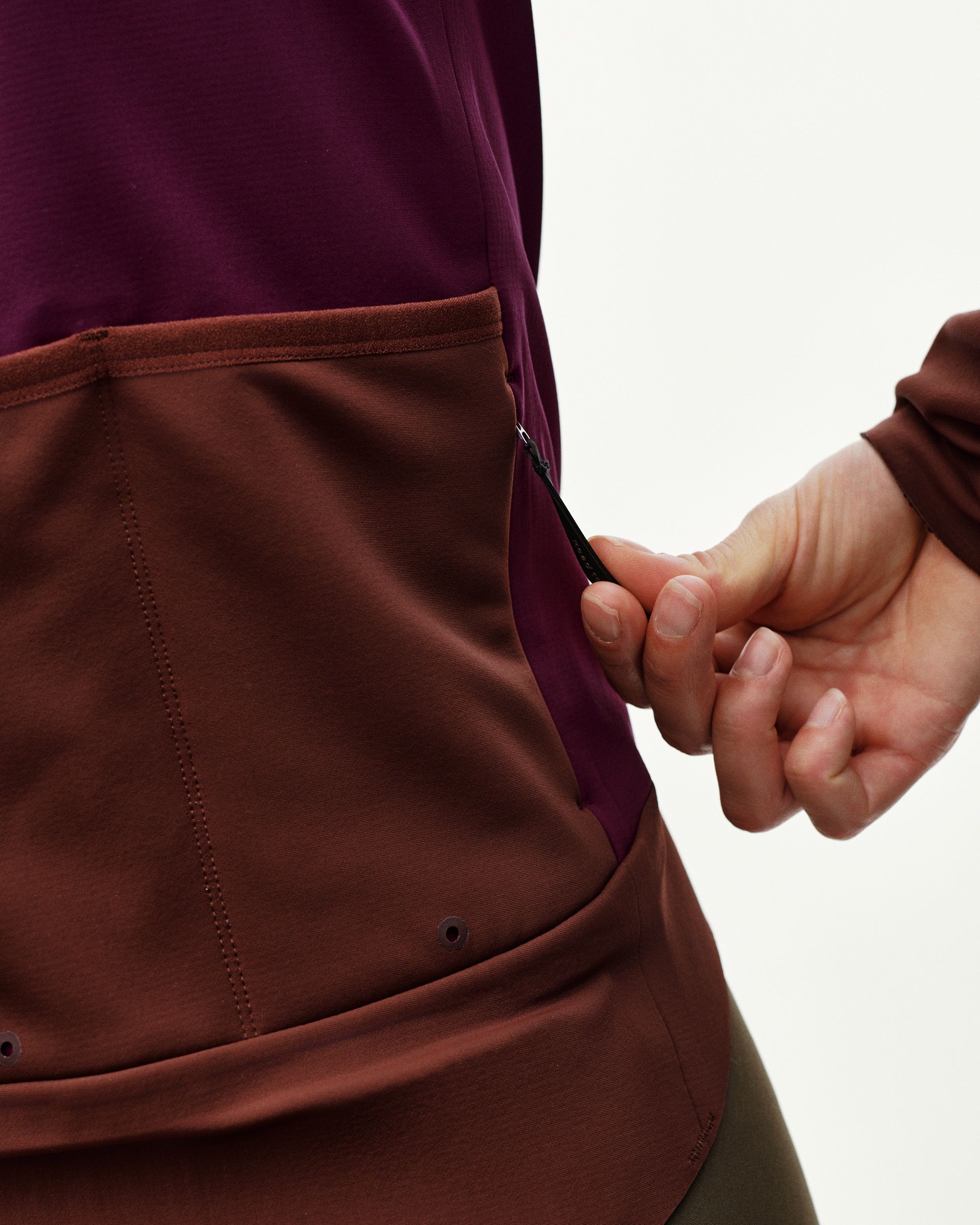 Dark Purple PAS Mechanism Thermal cycling jacket, side detail on model showing zip rear pocket