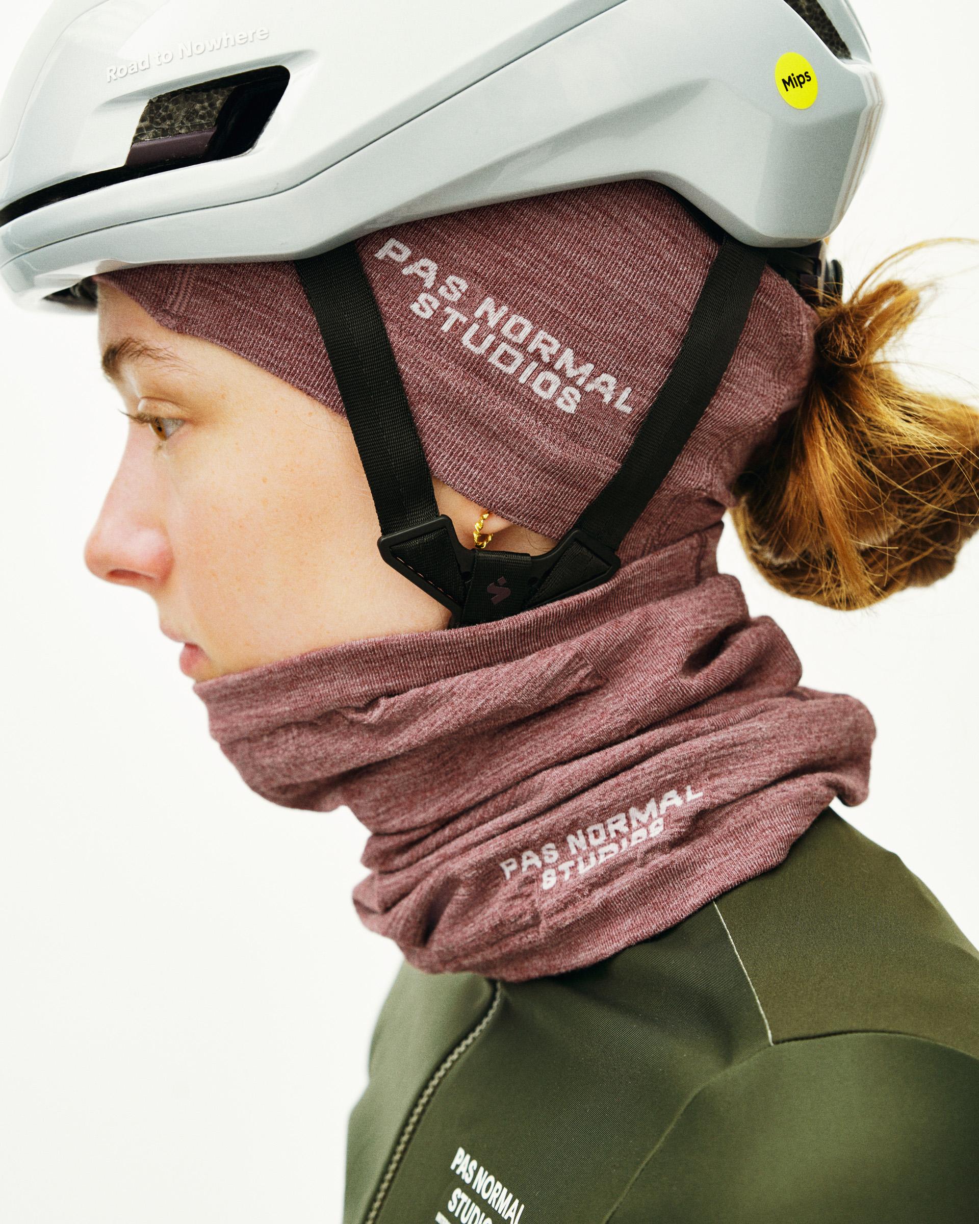 Maroon Logo Merino Knit beanie on model with white text and ribbed knit texture