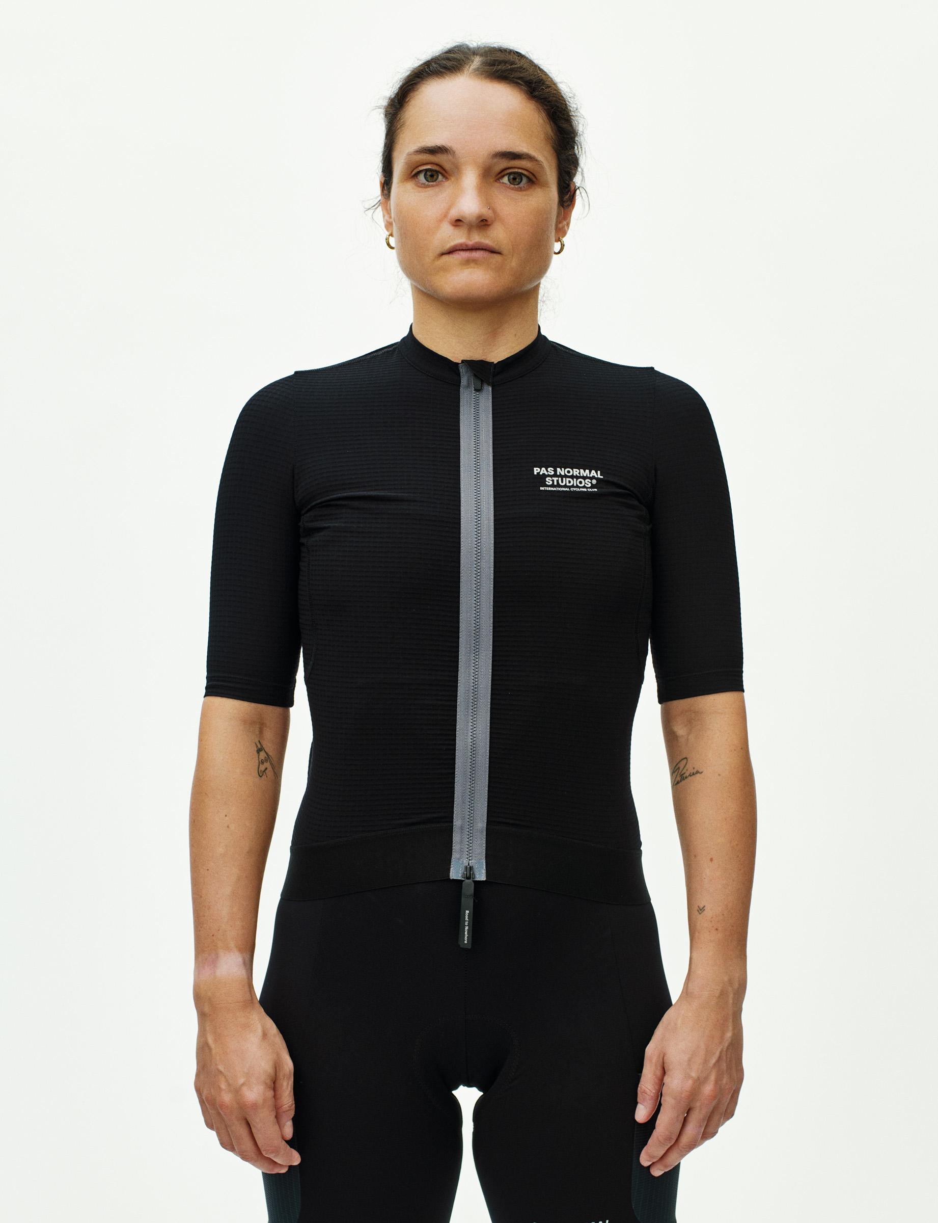 Black Escapism cycling jersey on model with half zip and textured fabric panels