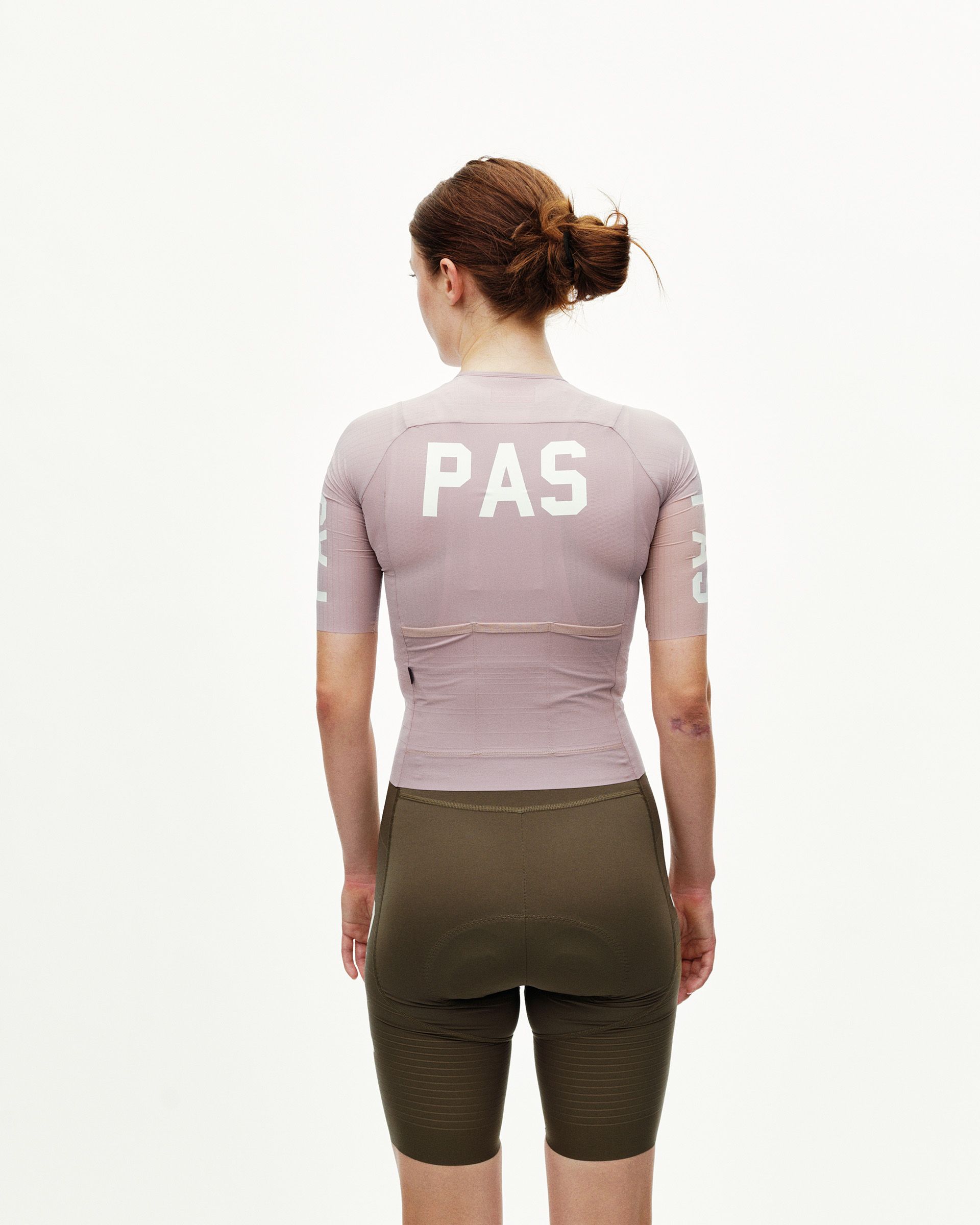 Taupe Rose PAS Mechanism Pro women's cycling jersey on model, rear view with white PAS back print