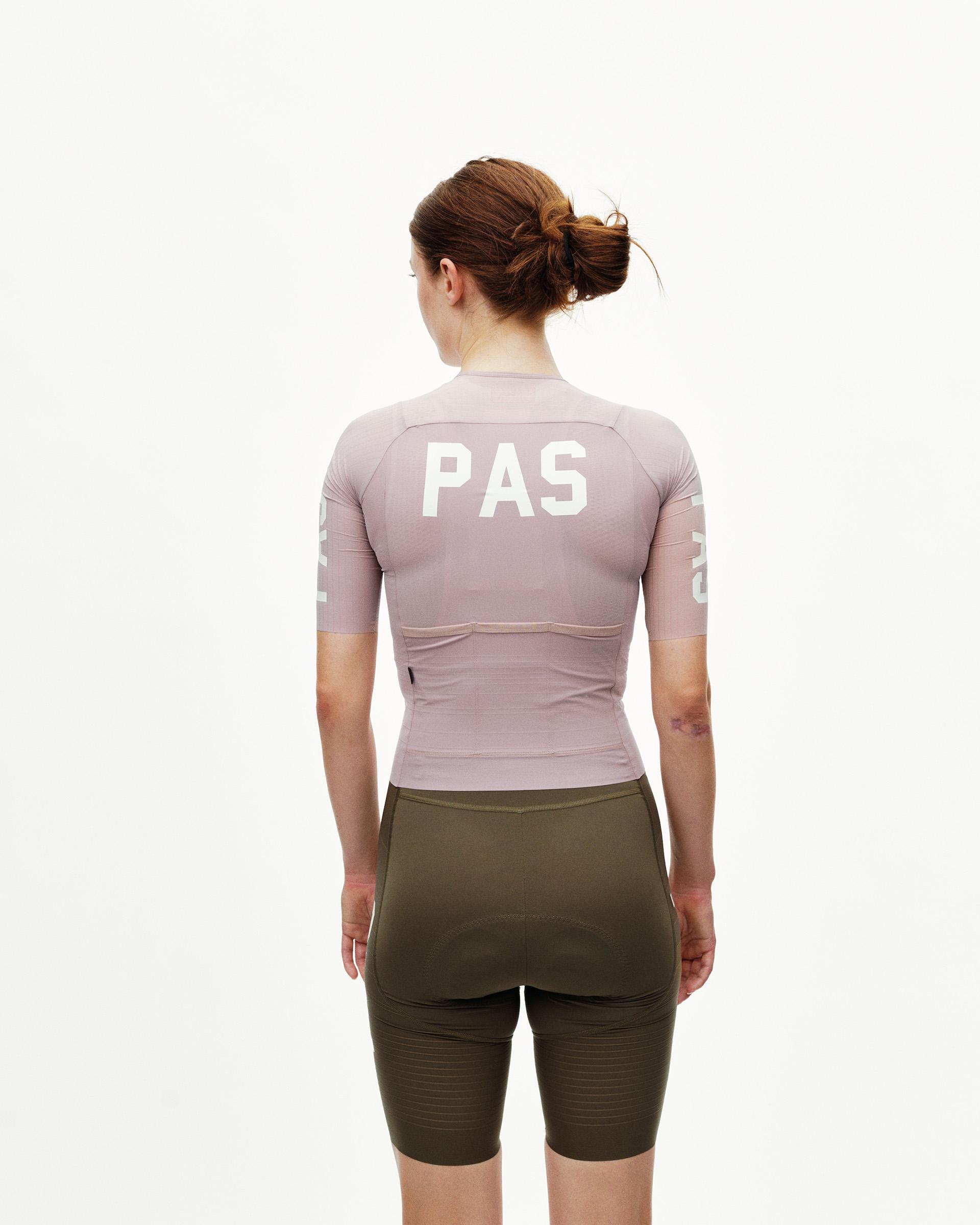 Taupe Rose PAS Mechanism Pro women's cycling jersey on model, rear view with white PAS back print