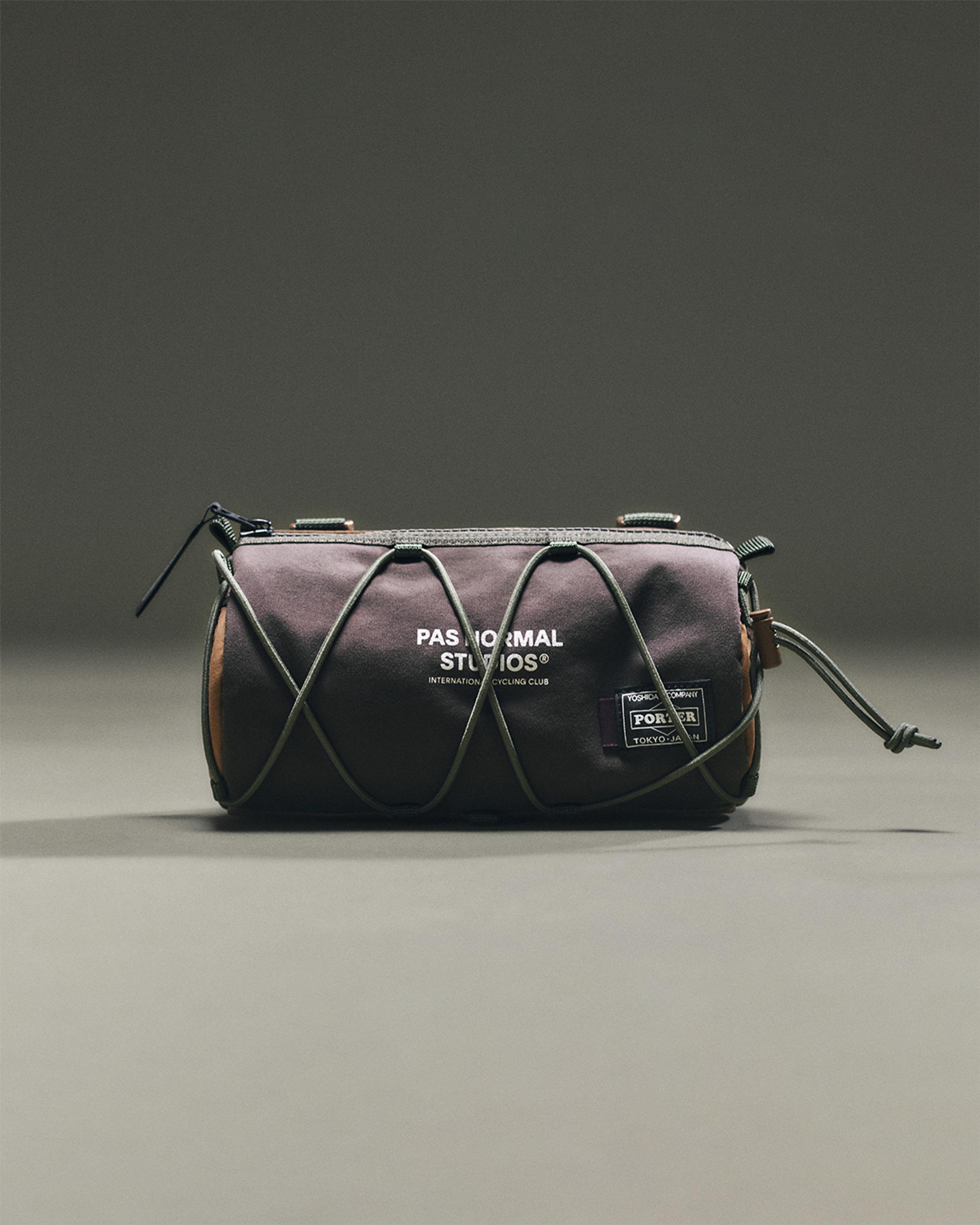 Light Brown Porter-Yoshida handlebar bag, front view with cross bungee cord lacing and Porter patch