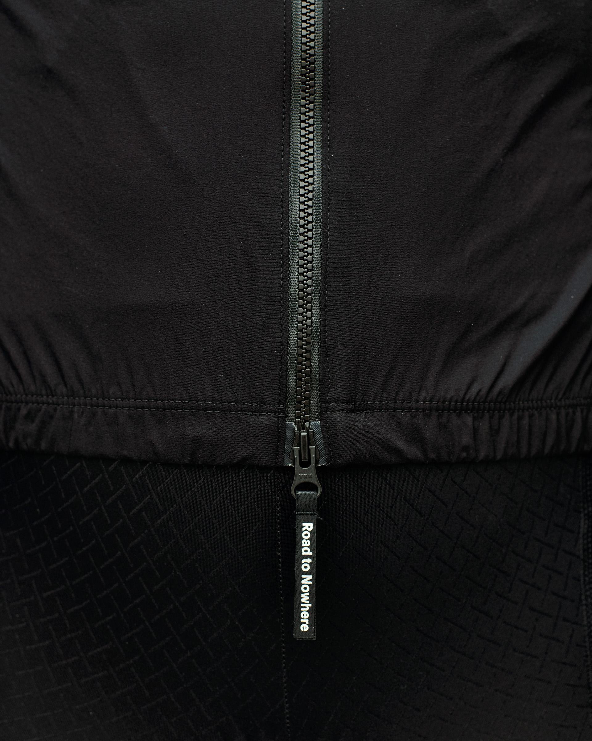 Black Mechanism Stow Away cycling jacket, detail view of centre zip with Road to Nowhere zip pull