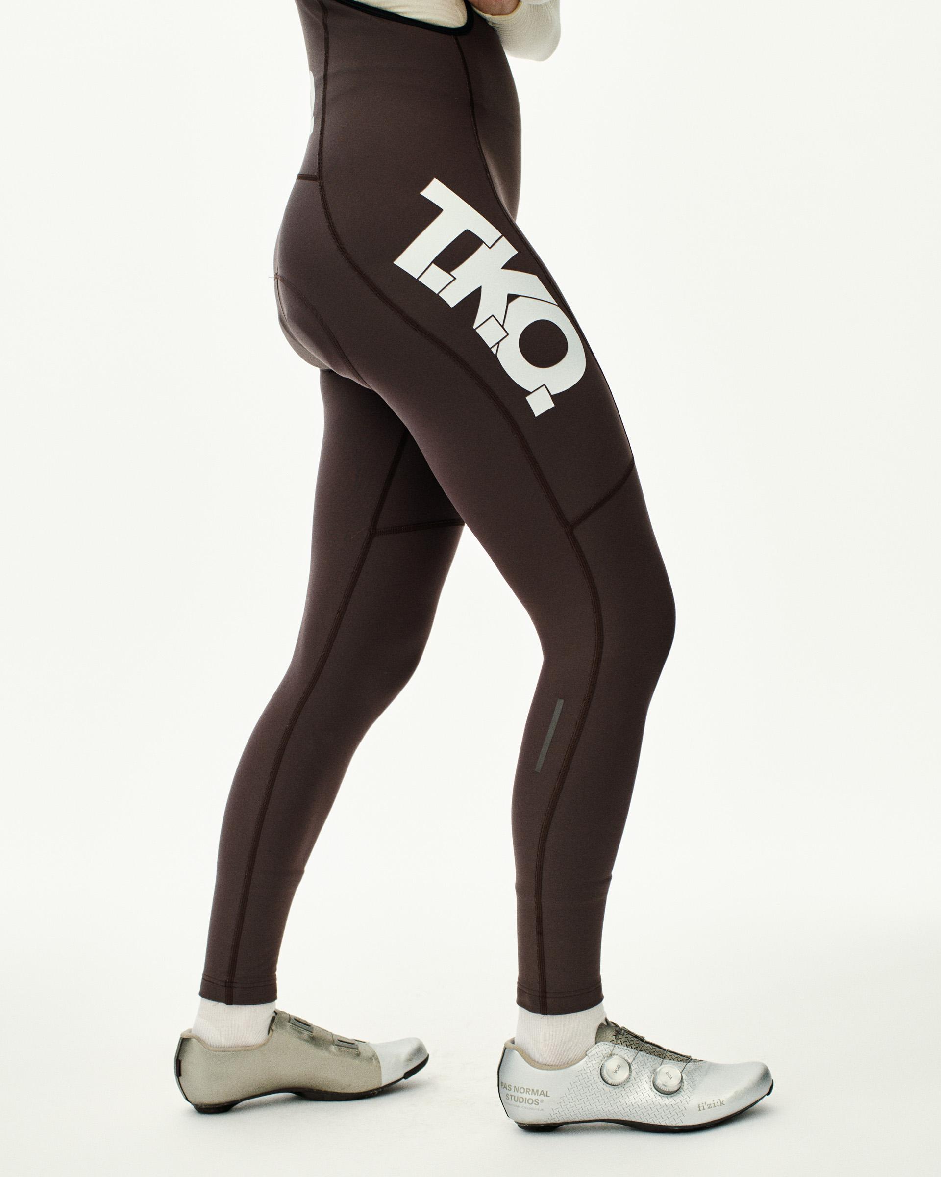 Dark Purple T.K.O. Essential Thermal Long cycling bibs on model, side view with white T.K.O. thigh print