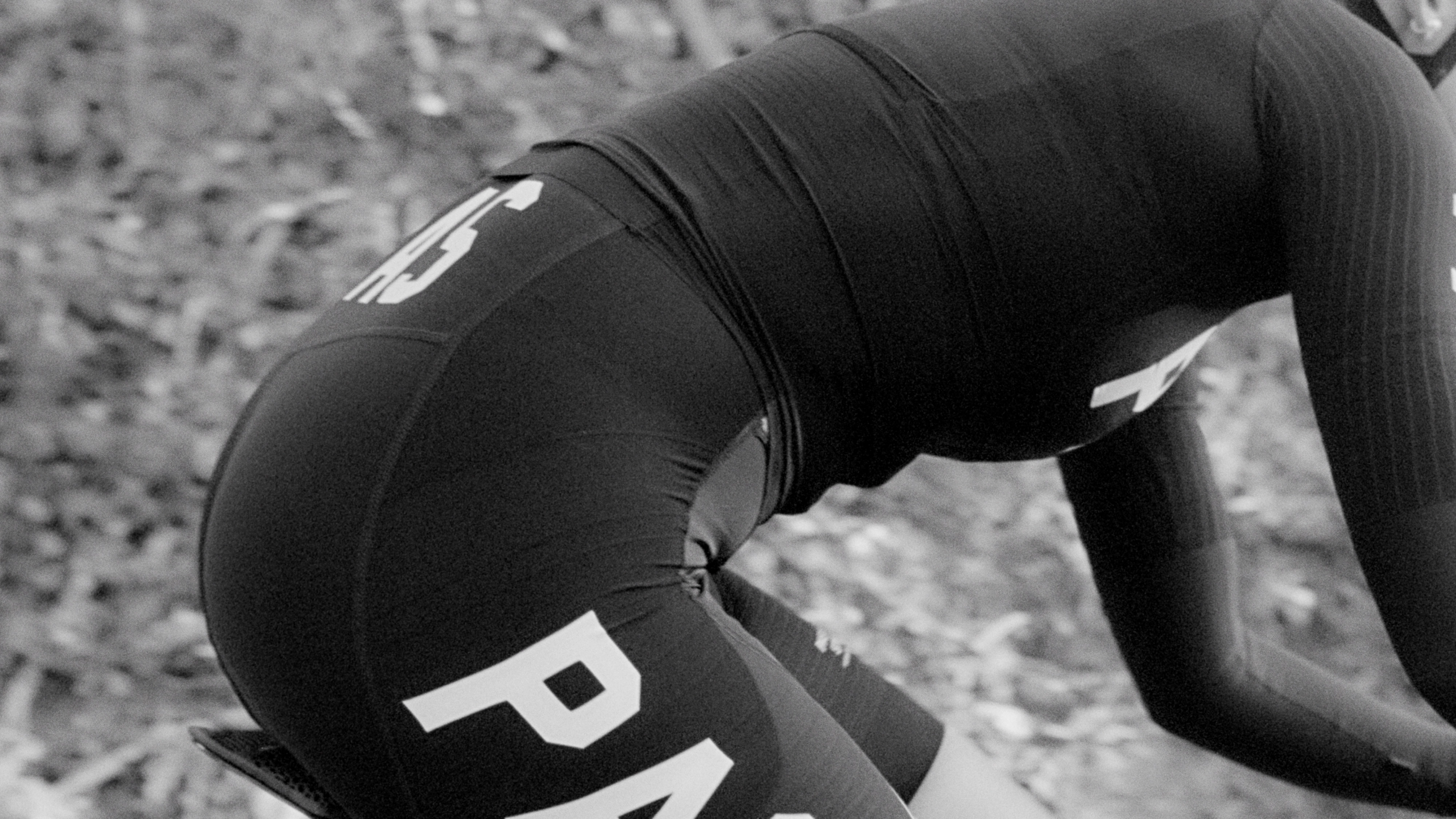 Black PAS Mechanism Pro cycling bibs on model, side view with white logo
