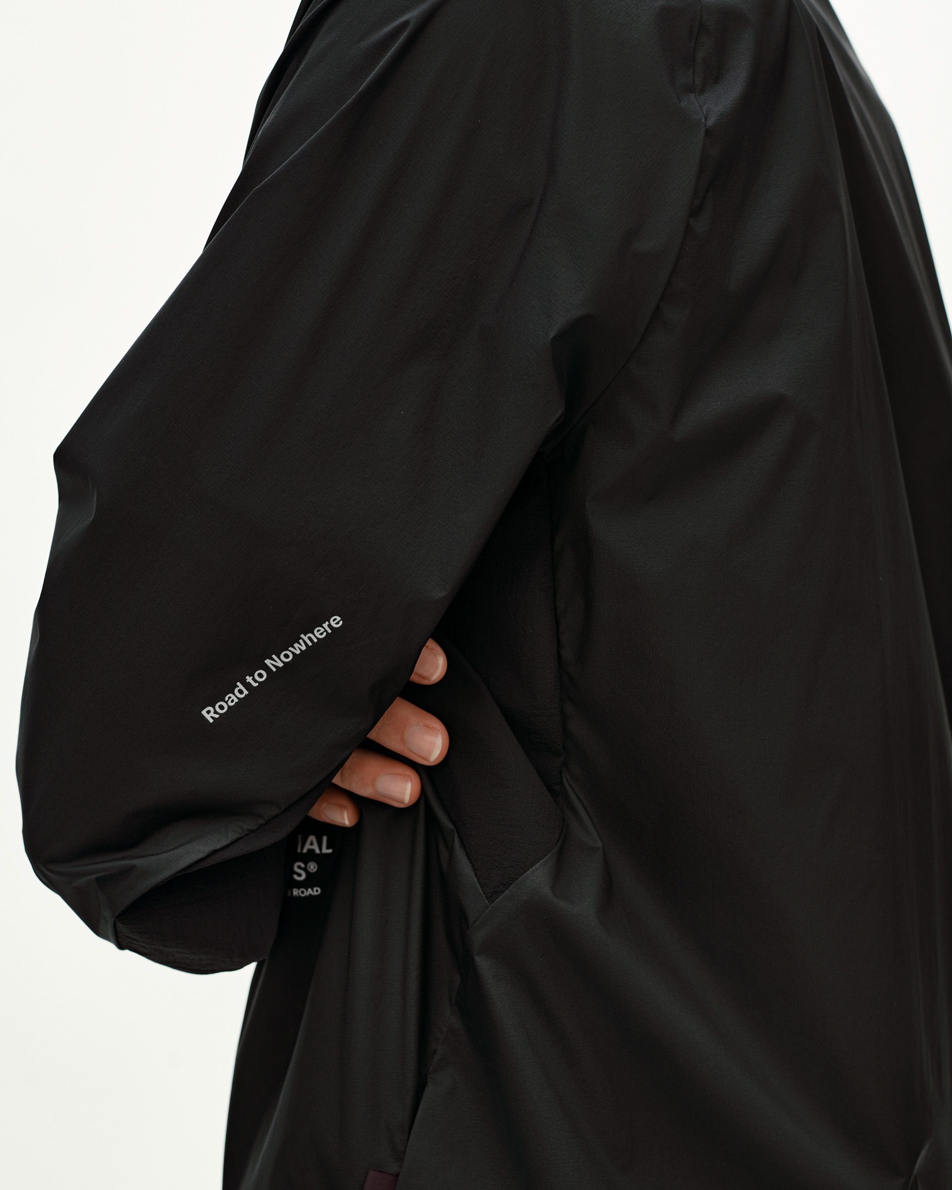 Black Balance Windproof jacket, side detail on model with Road to Nowhere sleeve text print