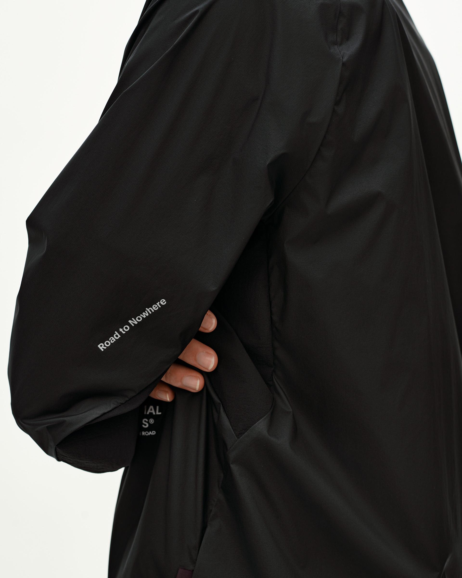 Black Balance Windproof jacket, side detail on model with Road to Nowhere sleeve text print