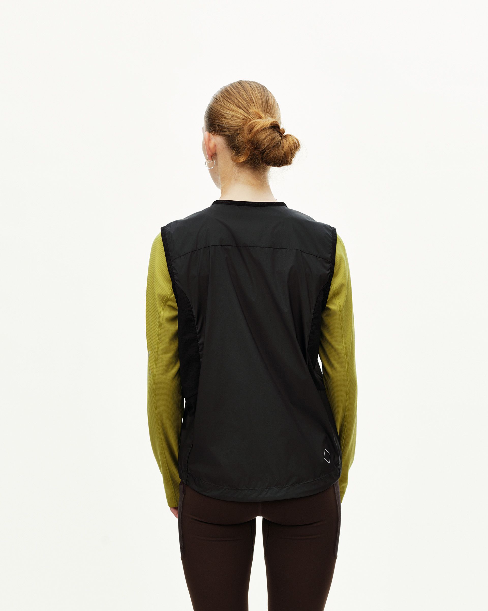 Black Balance Windproof cycling vest on model, rear view with open sides