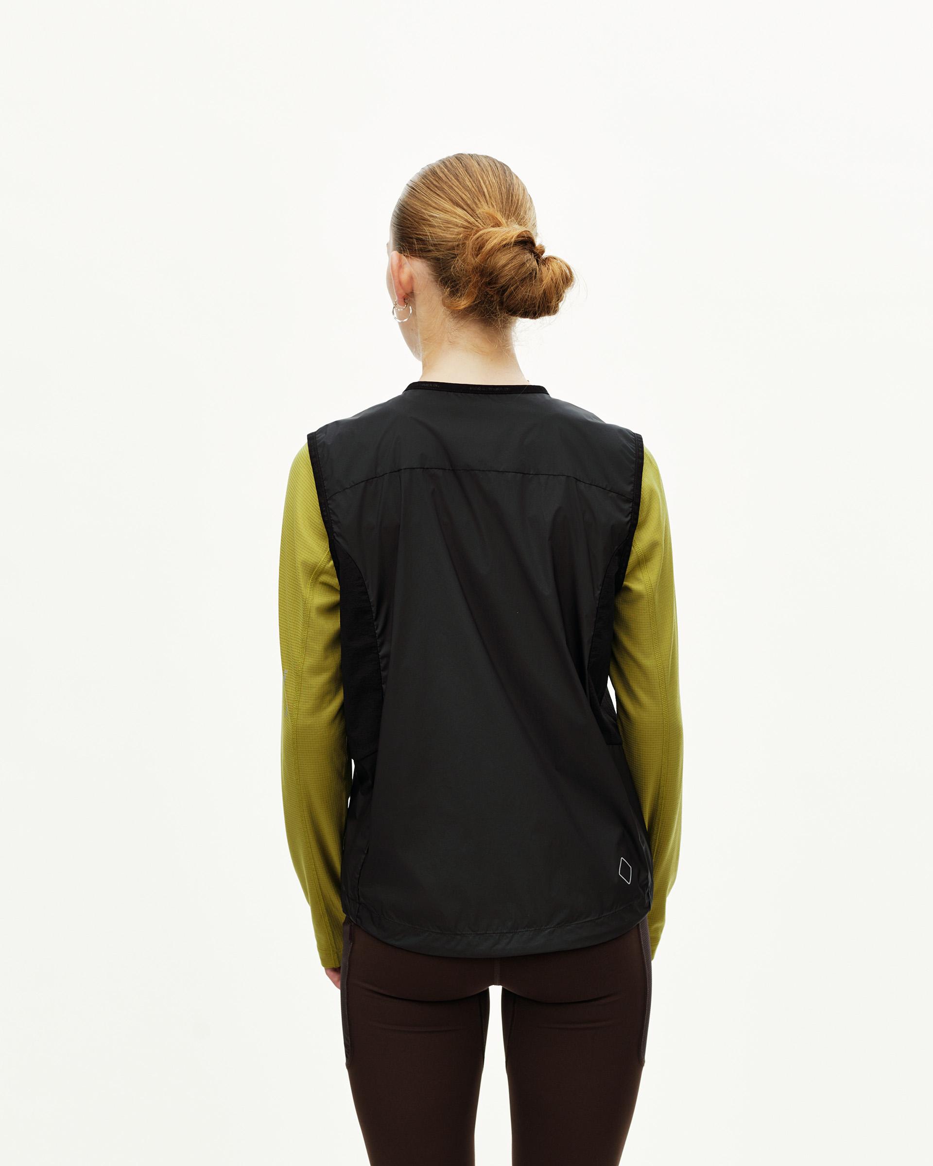 Black Balance Windproof cycling vest on model, rear view with open sides