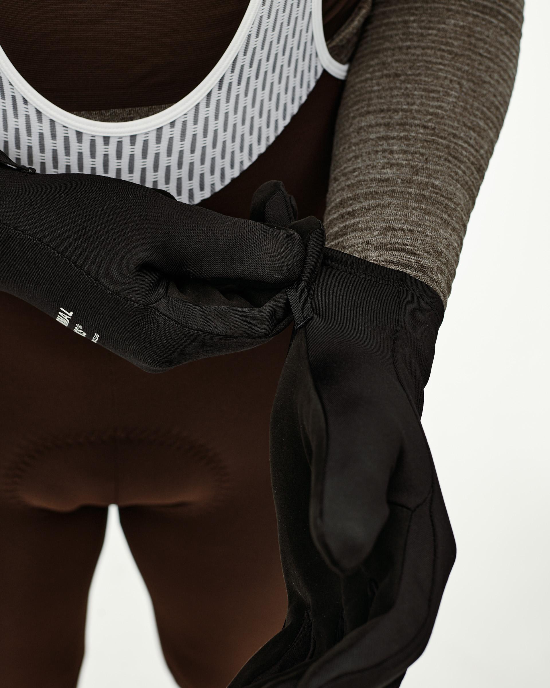 Black Logo Light cycling gloves on model, detail view showing small text label on cuff