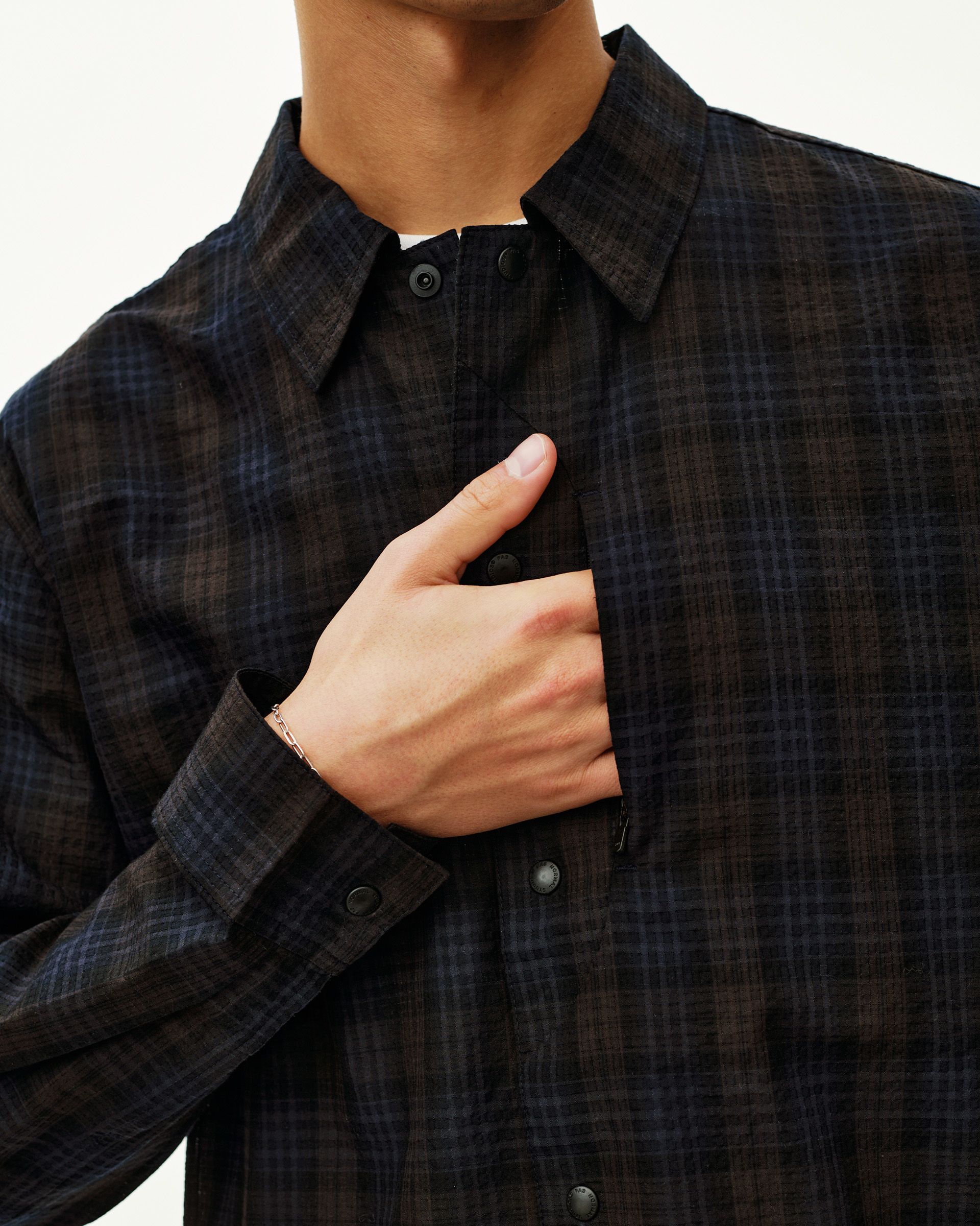 Dark Navy Off-Race Seersucker shirt on model, front detail view with snap buttons and check pattern