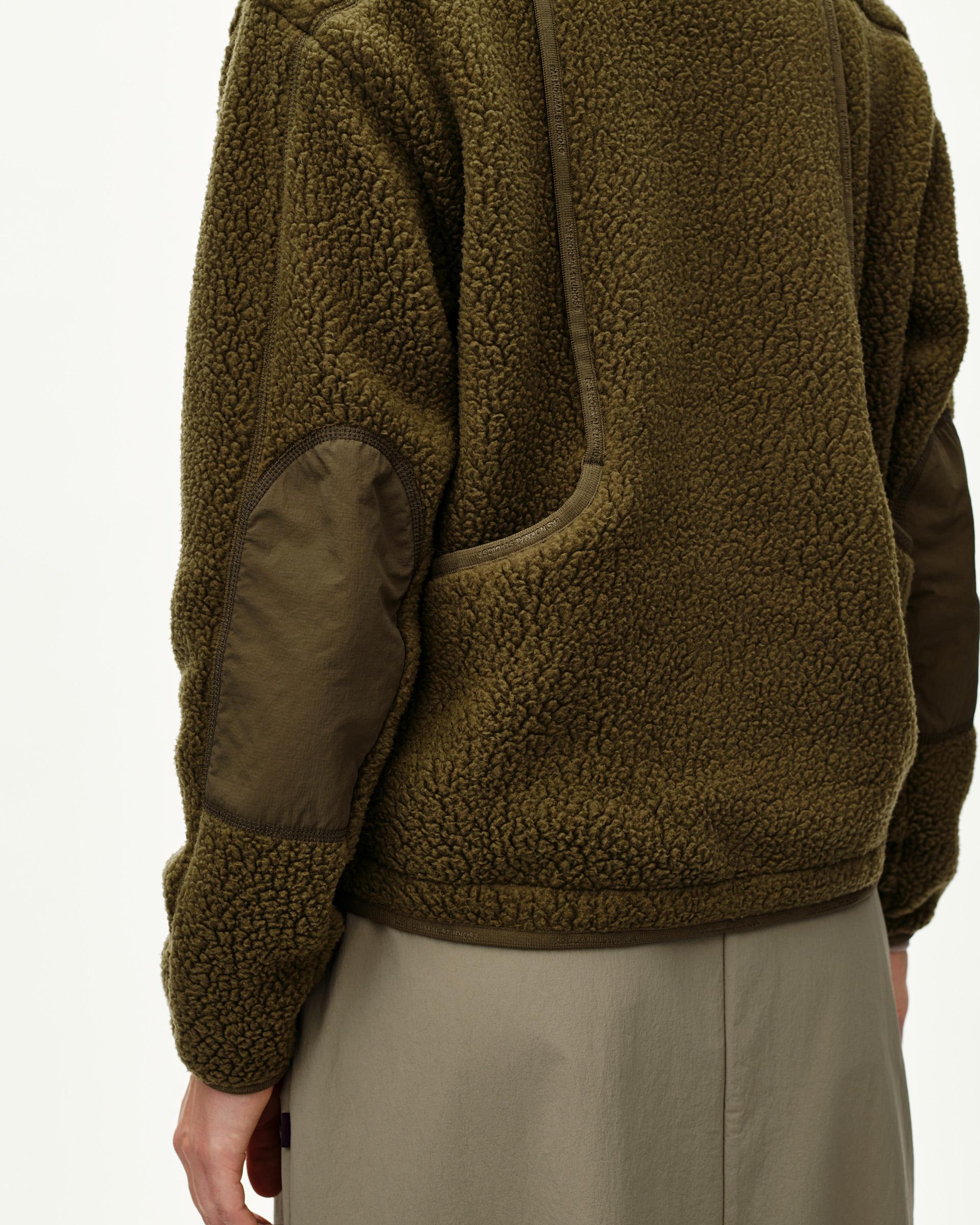 Deep Olive Off-Race Pile Fleece jacket on model, side detail view with contrast elbow patch and zip pocket