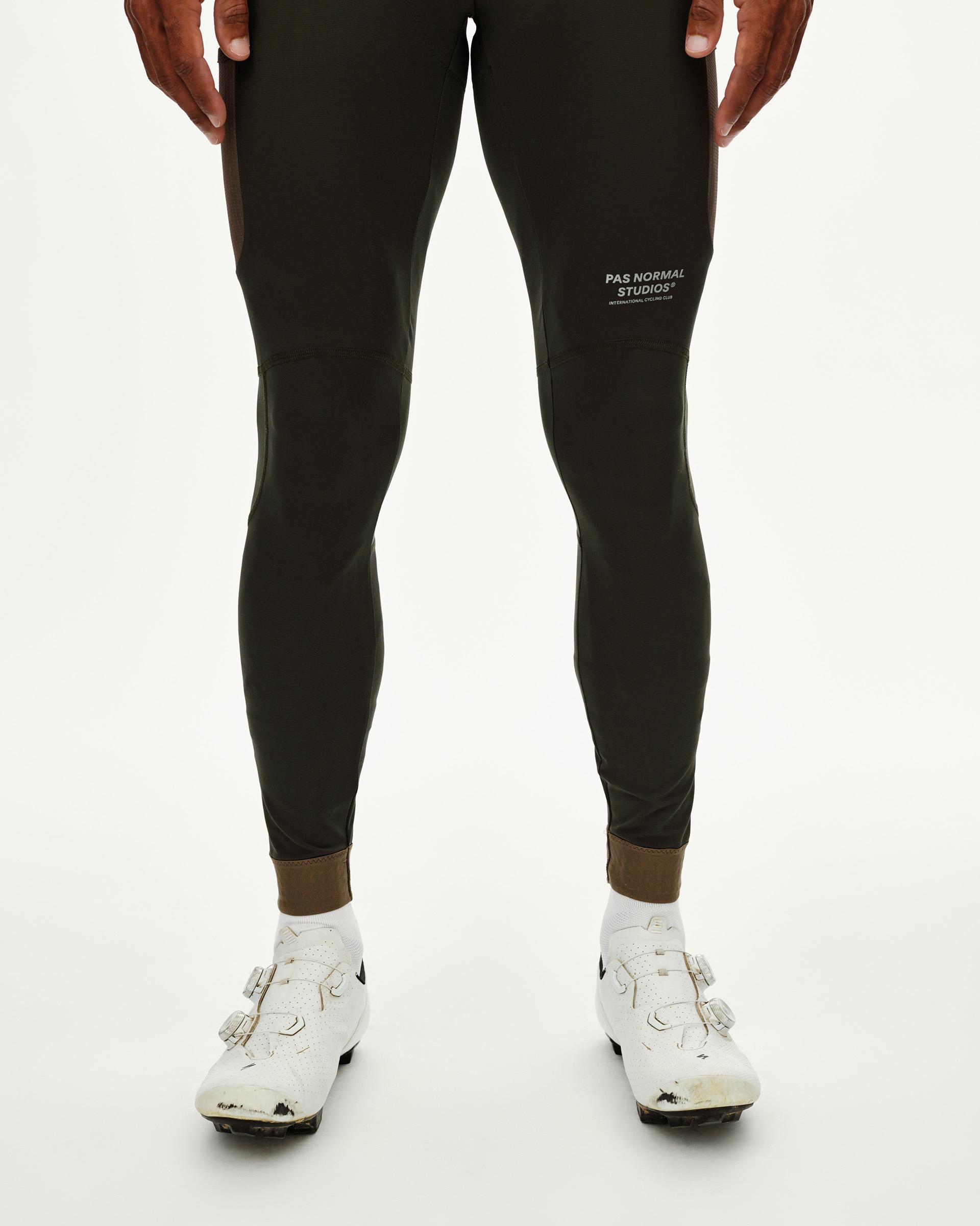 Dark Olive Escapism Long Cargo cycling bibs on model, front view with contrast ankle cuff