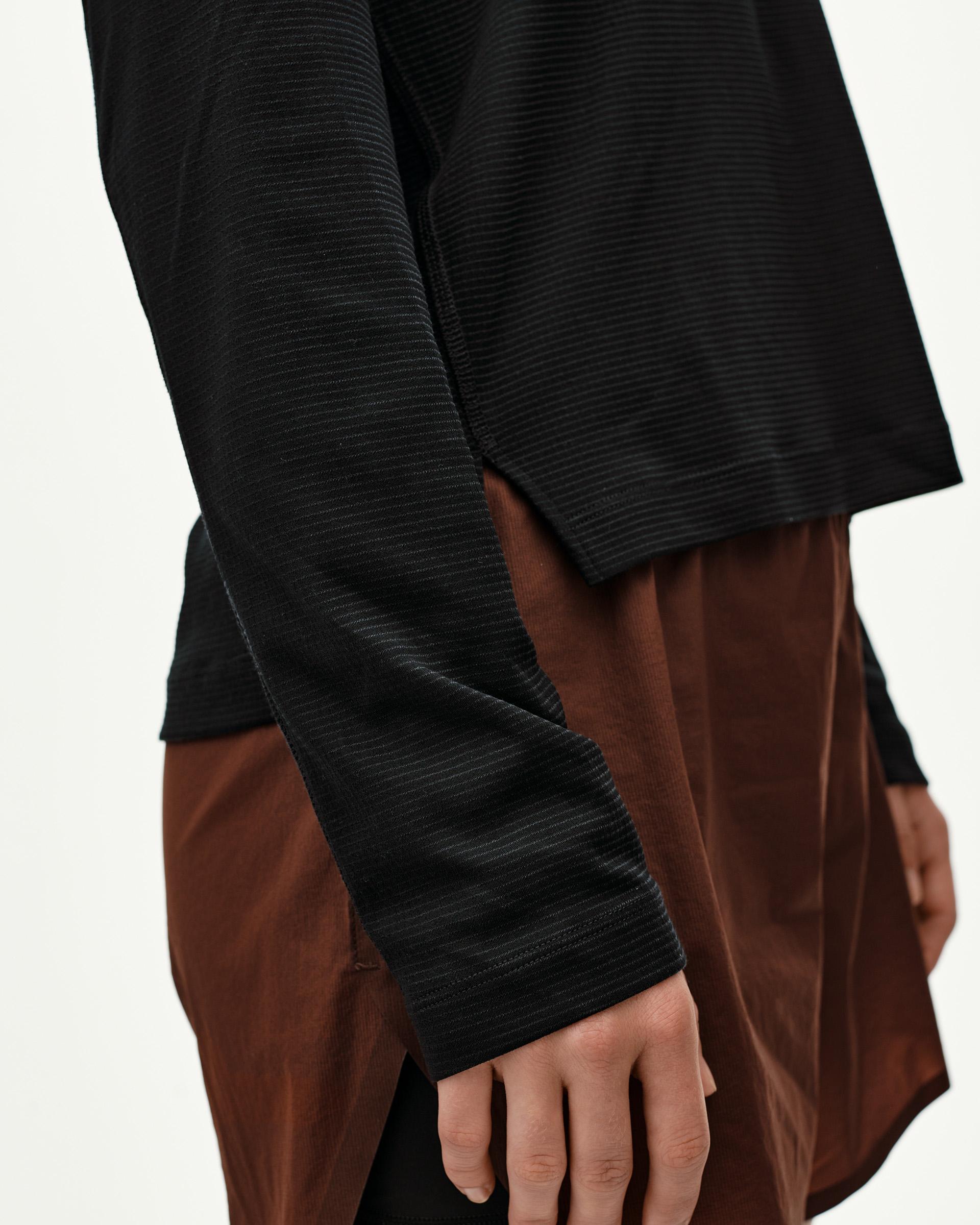 Black Balance long sleeve T-shirt, side detail on model showing ribbed texture and fitted cuff