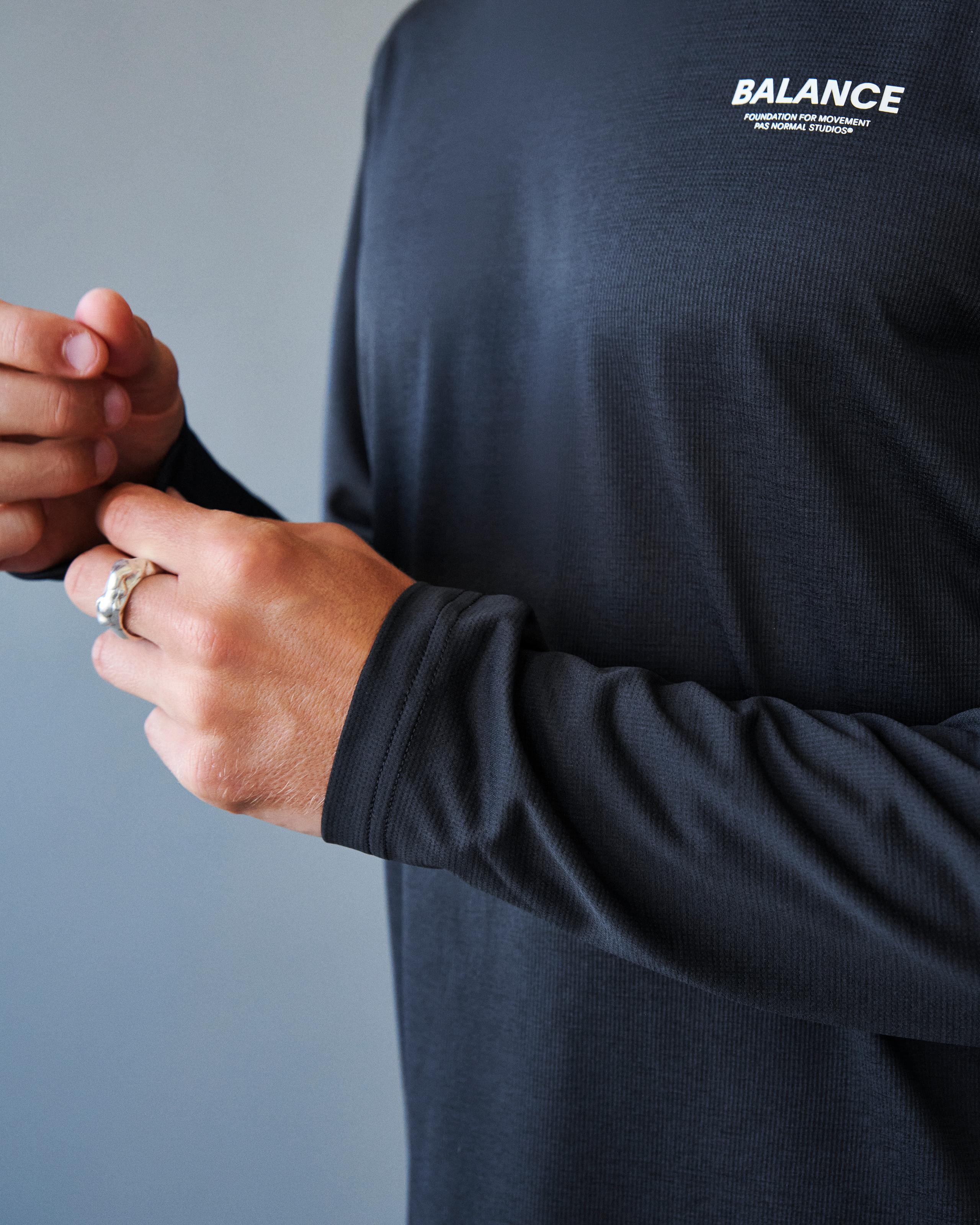 Black Balance long sleeve t-shirt on model showing ribbed cuff detail