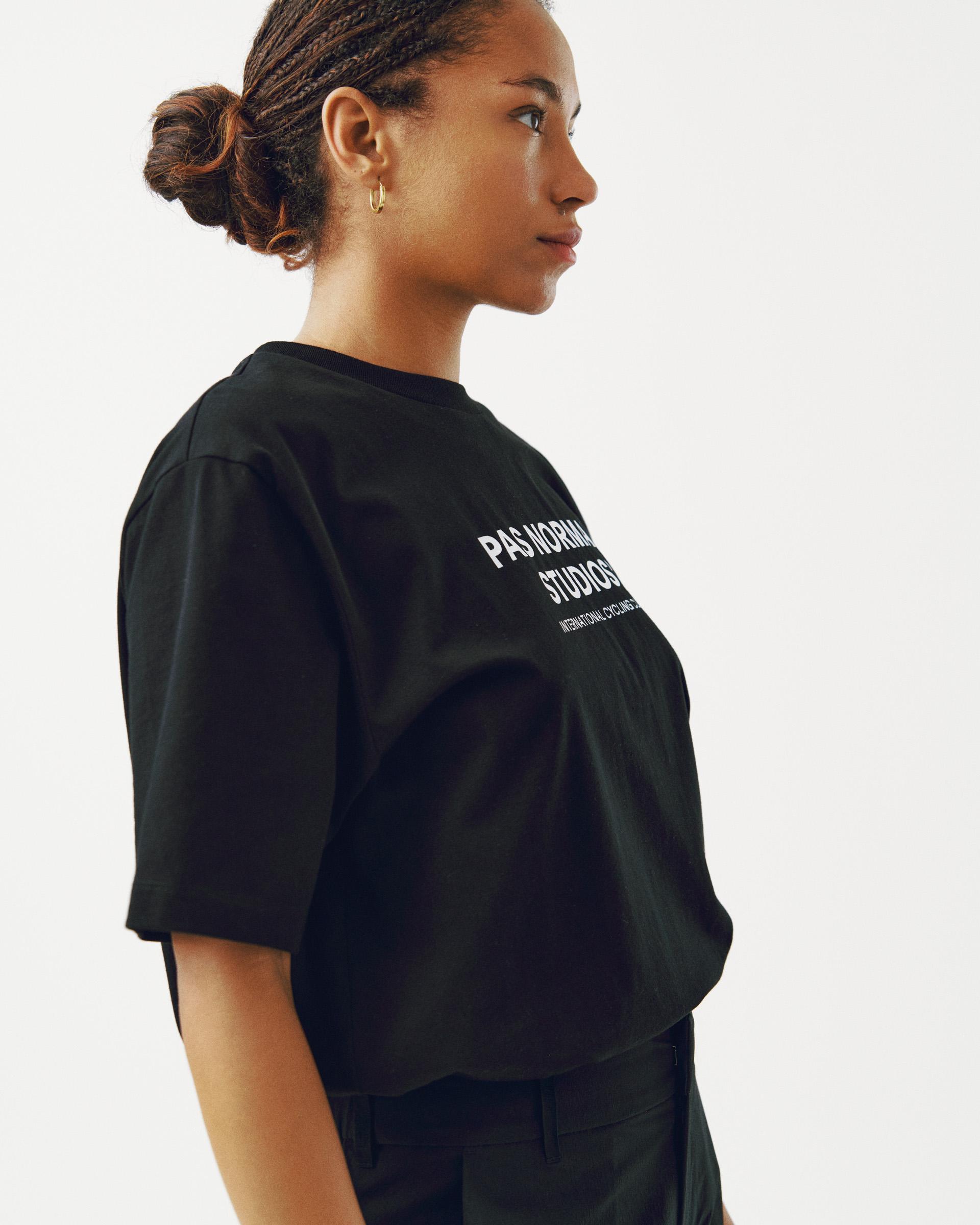 Black Off-Race Logo T-shirt on model, three-quarter side view with white chest print