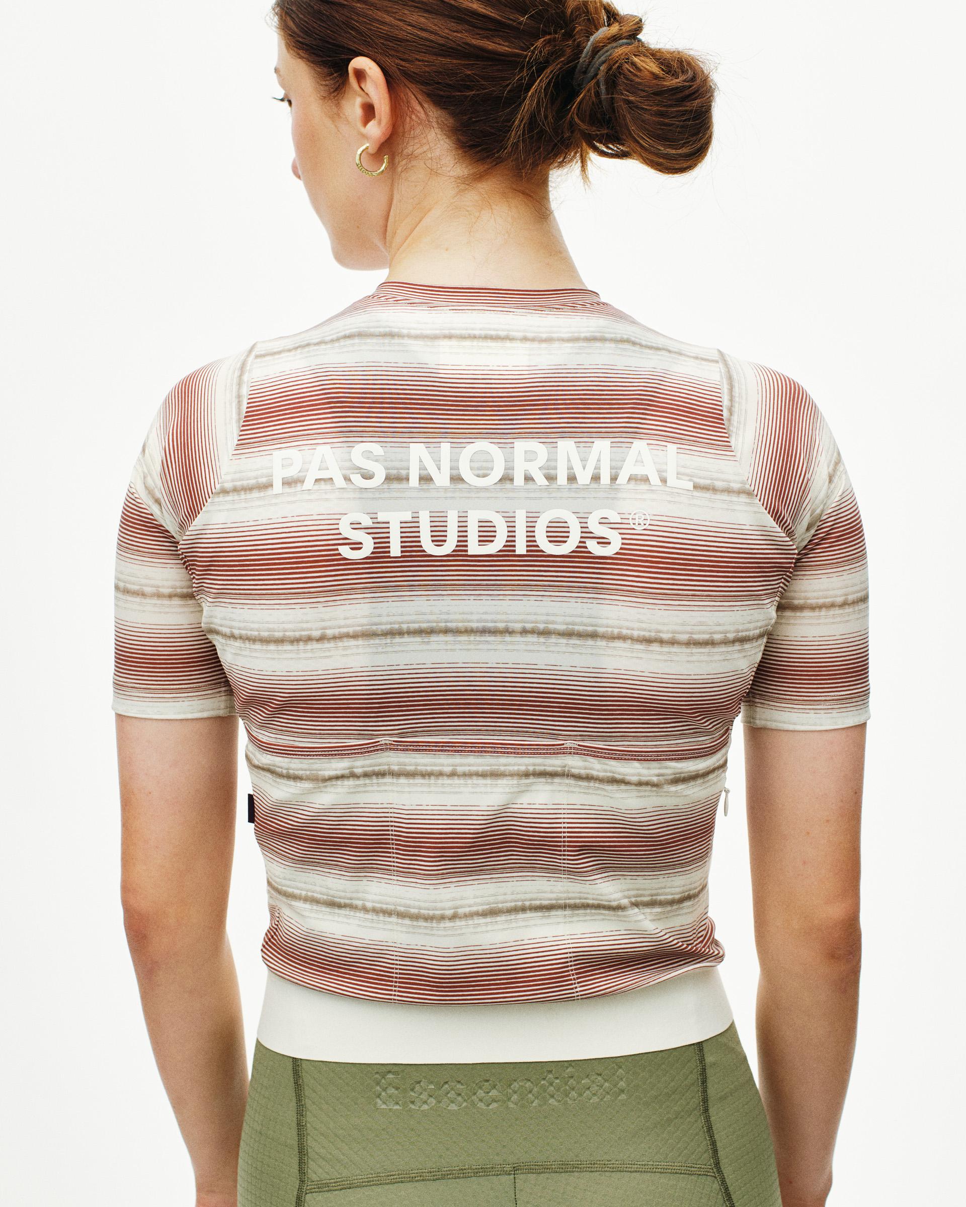 Off White Essential cycling jersey on model, rear view with horizontal stripes