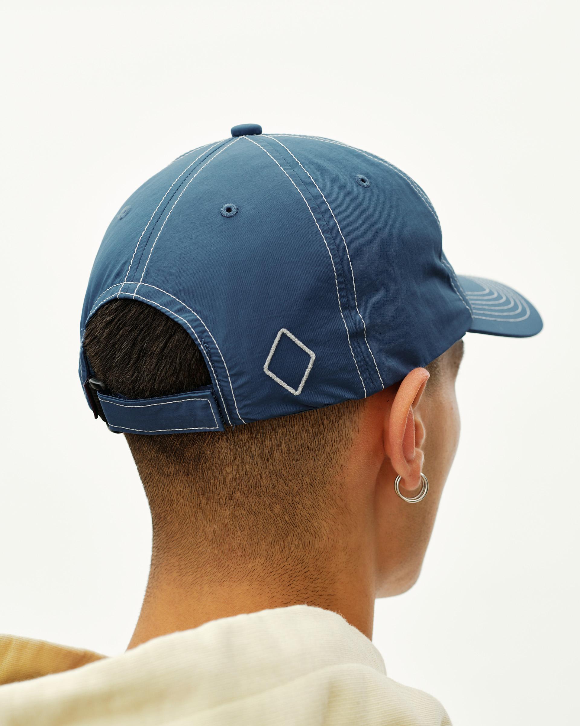 Ocean Blue Off-Race cap on model, rear view with contrast stitching and diamond logo patch