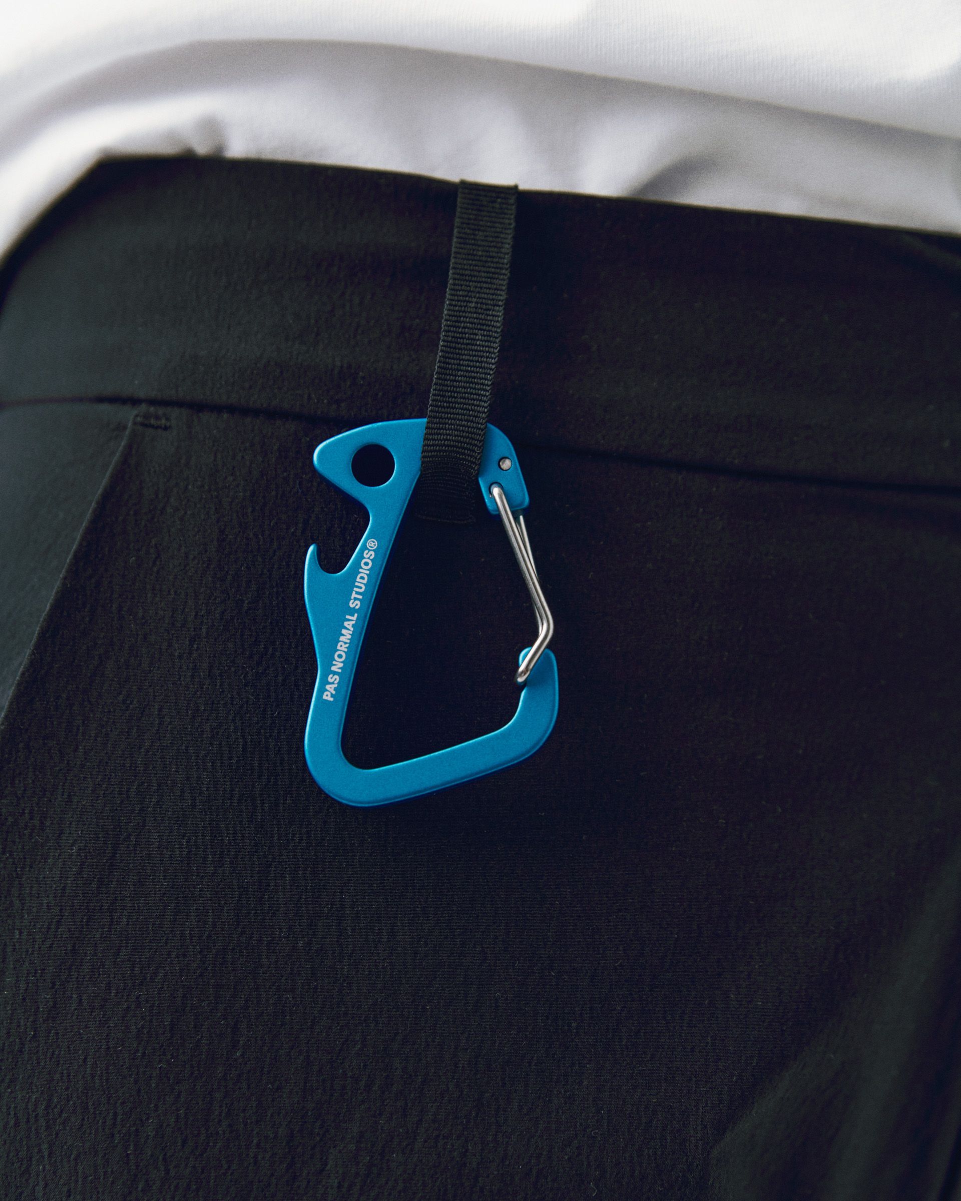 Blue Off-Race Branded carabiner, detail view with black webbing strap
