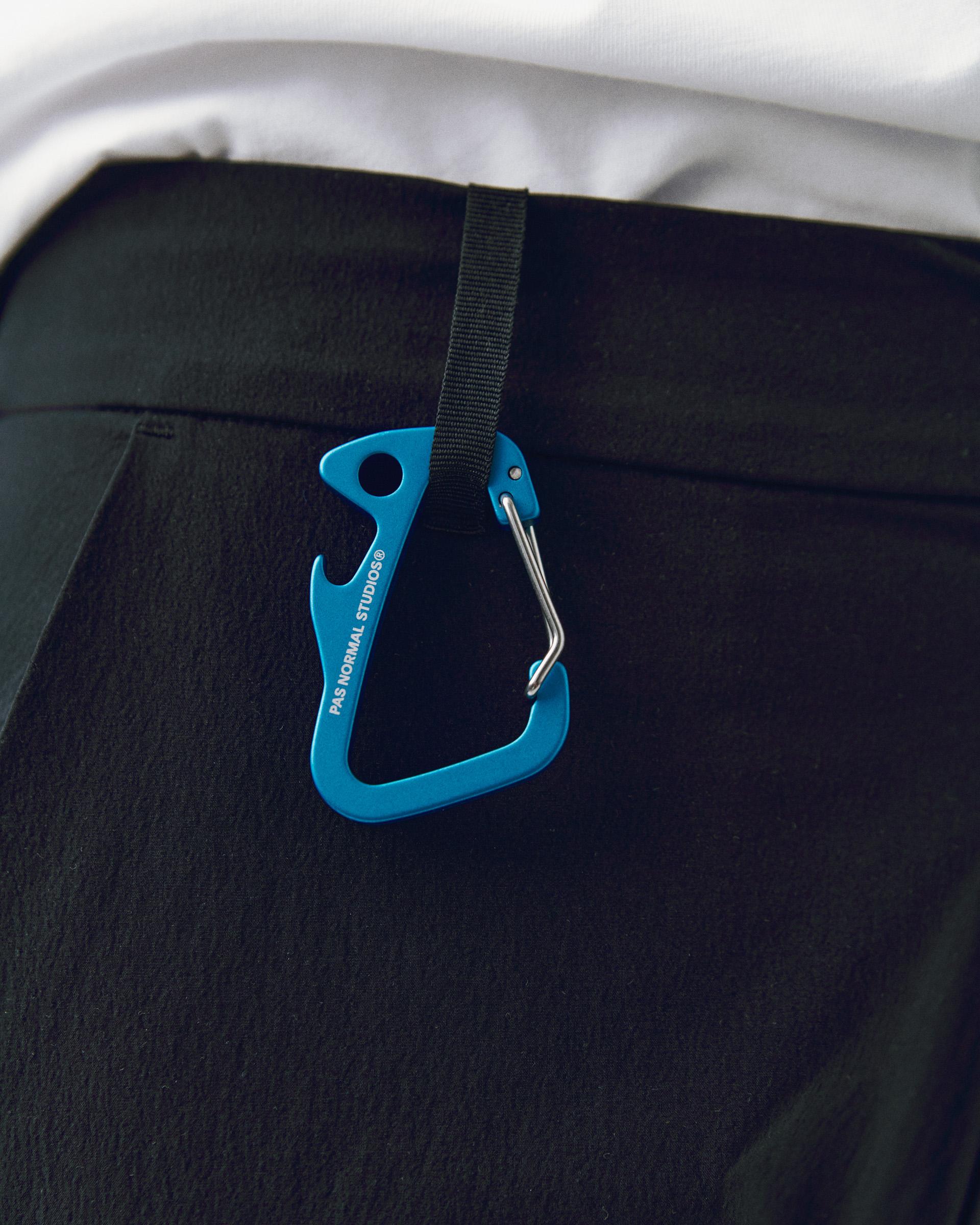 Blue Off-Race Branded carabiner, detail view with black webbing strap