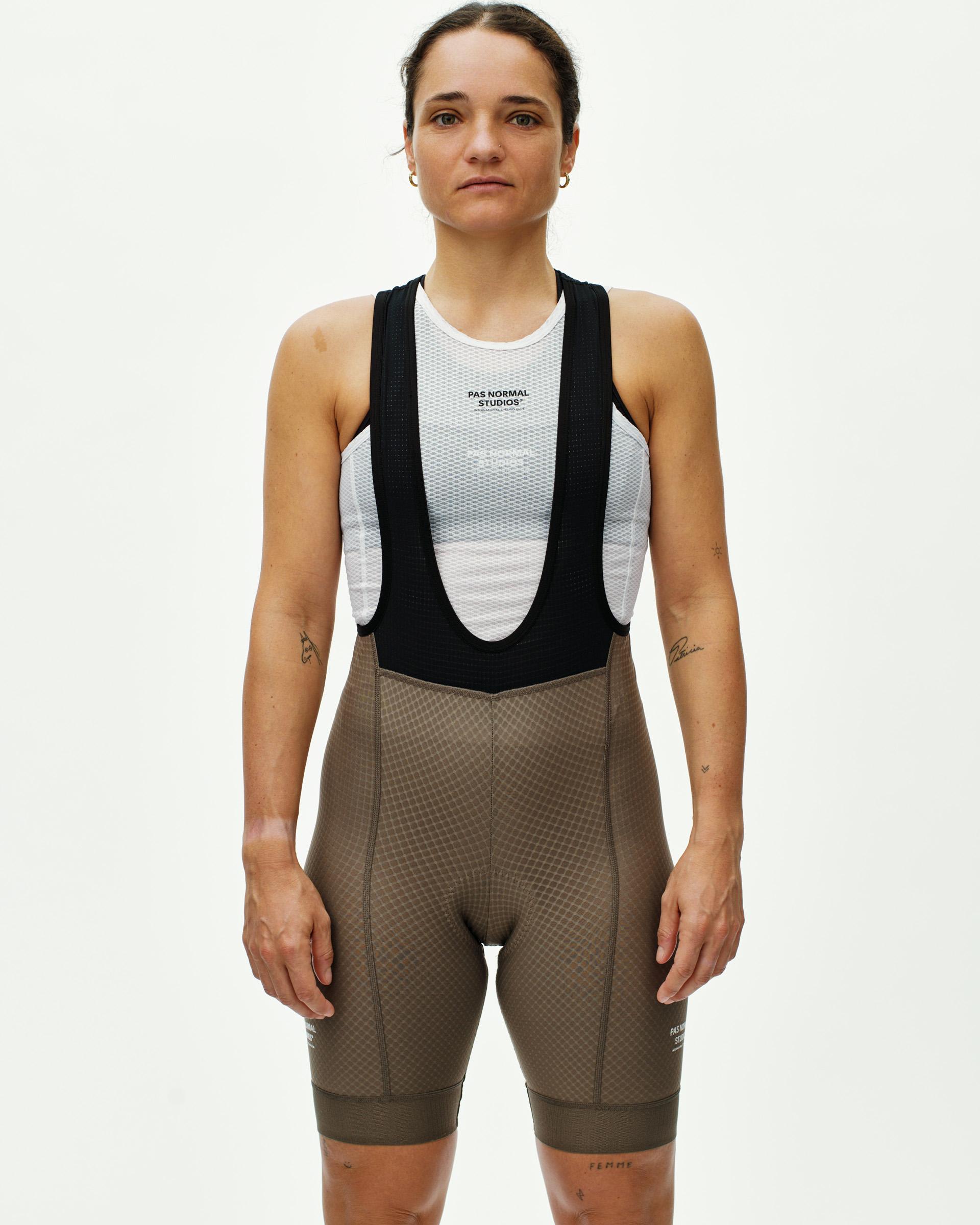 Earth Essential bibs on model, front view with black straps and textured fabric panels