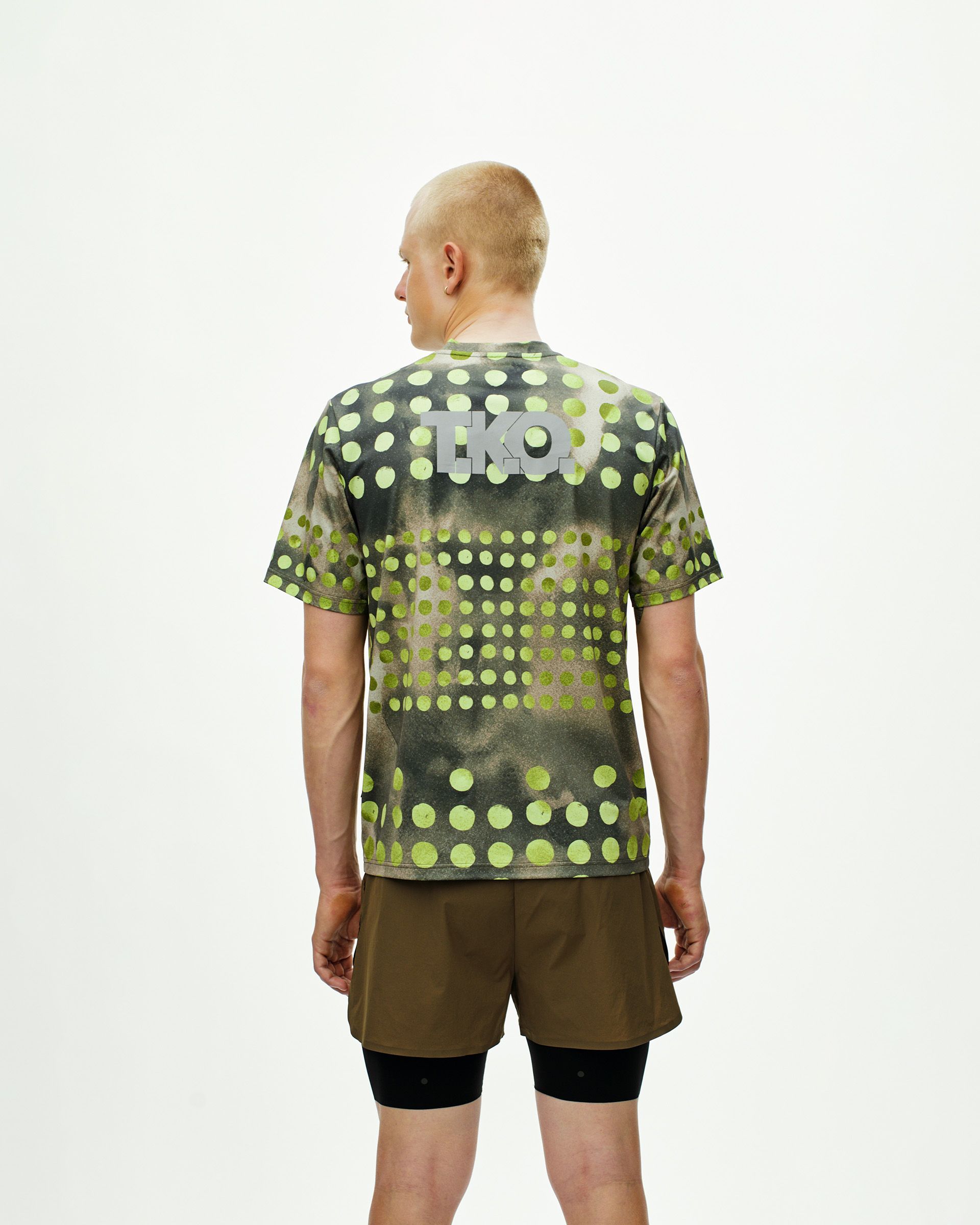 Green T.K.O. Balance t-shirt, rear view on model with polka dot print and back logo