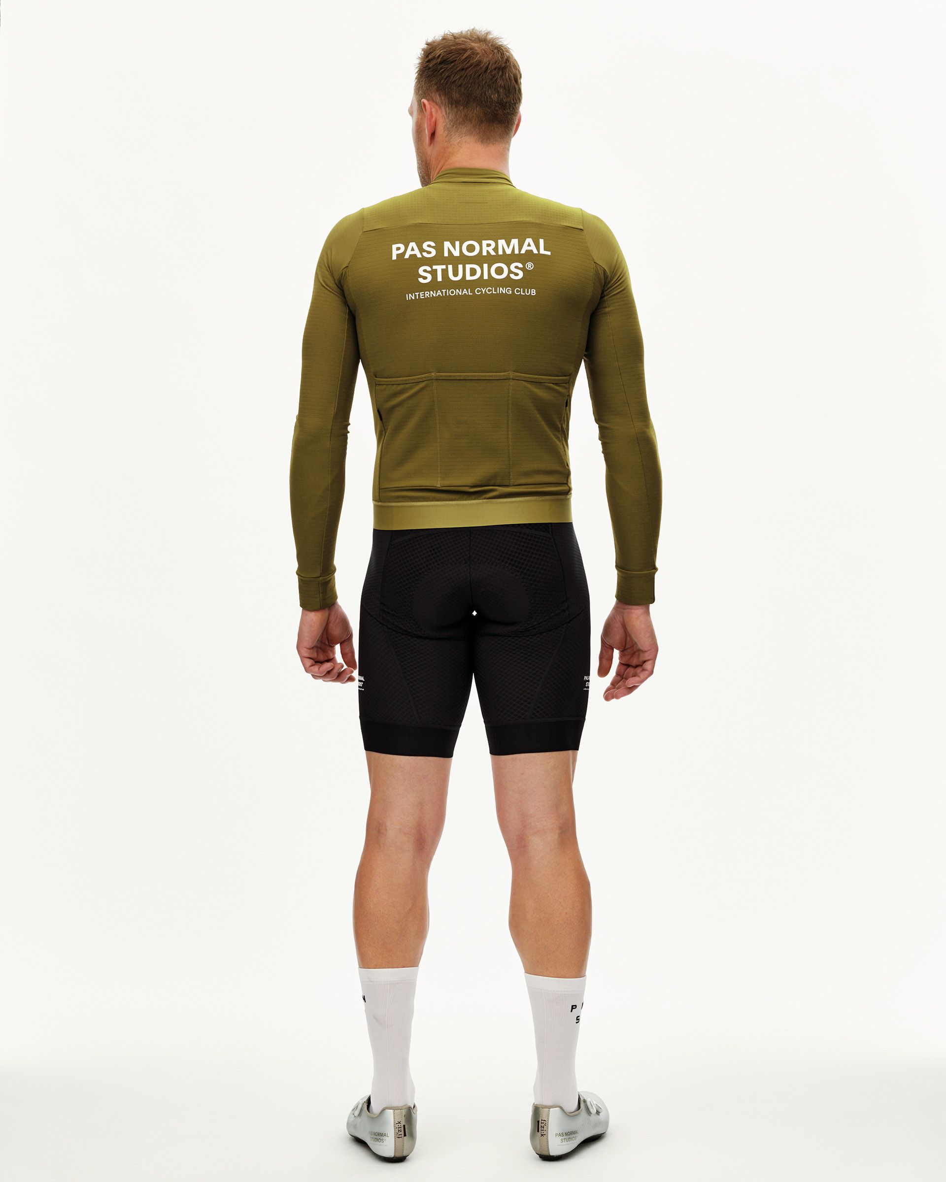 Khaki Green Essential long sleeve cycling jersey on model, rear view with white back print