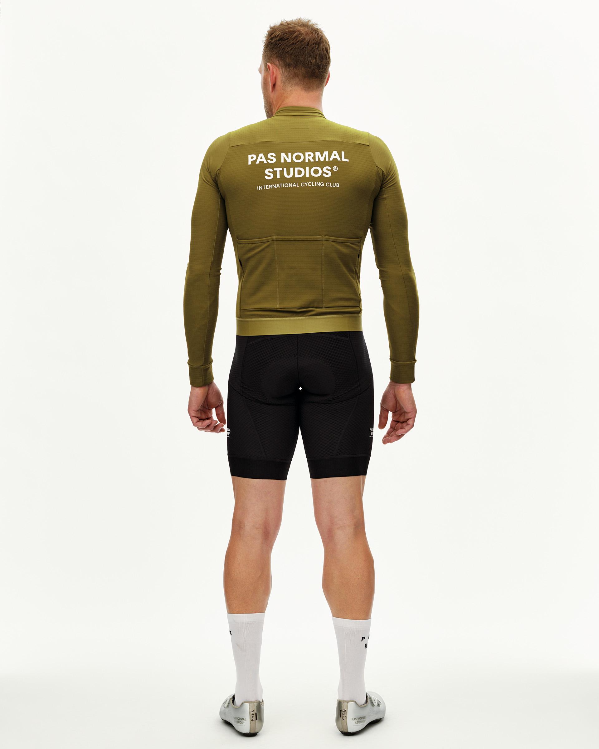 Khaki Green Essential long sleeve cycling jersey on model, rear view with white back print