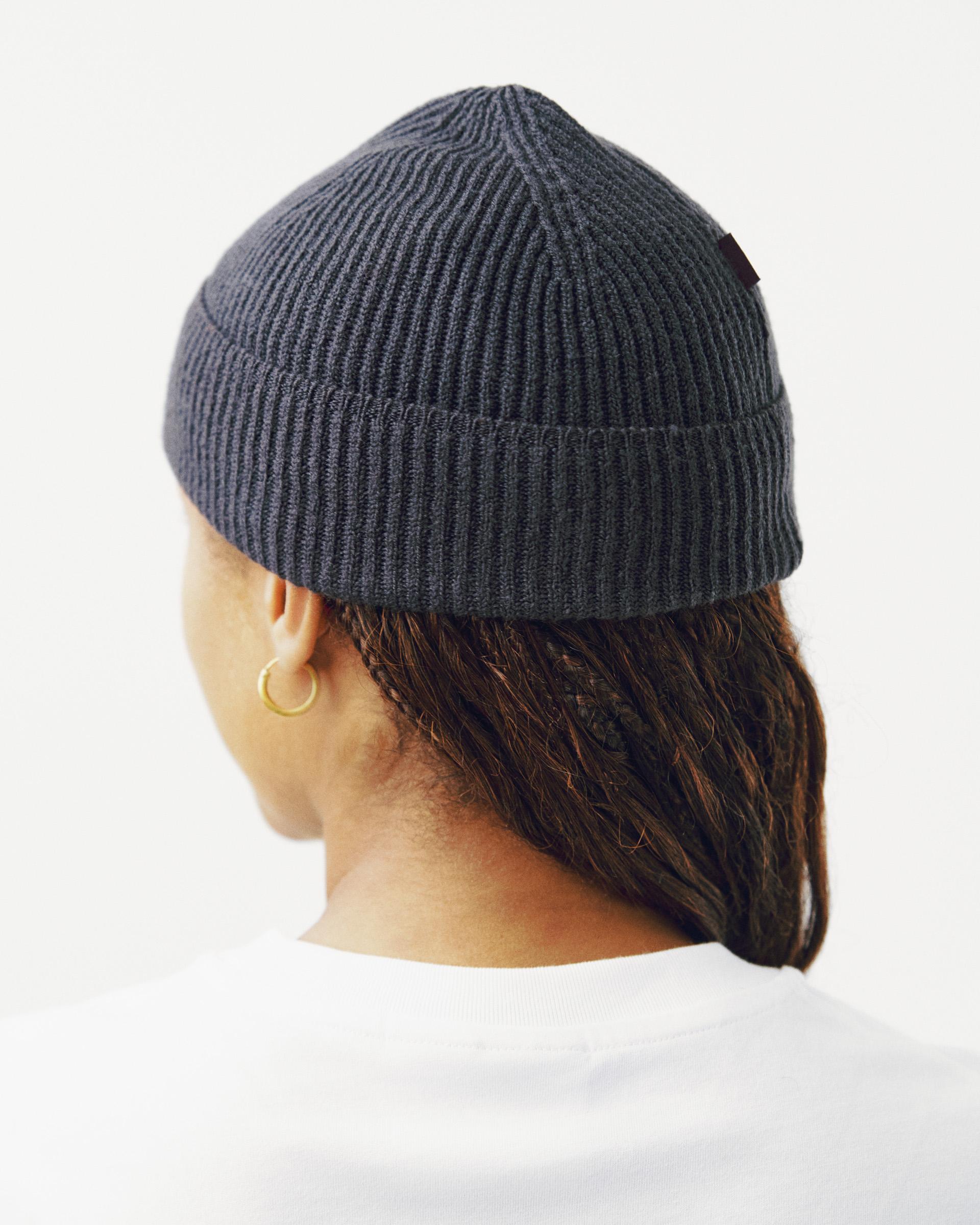 Grey Off-Race Merino Knit beanie on model, side view with ribbed knit texture